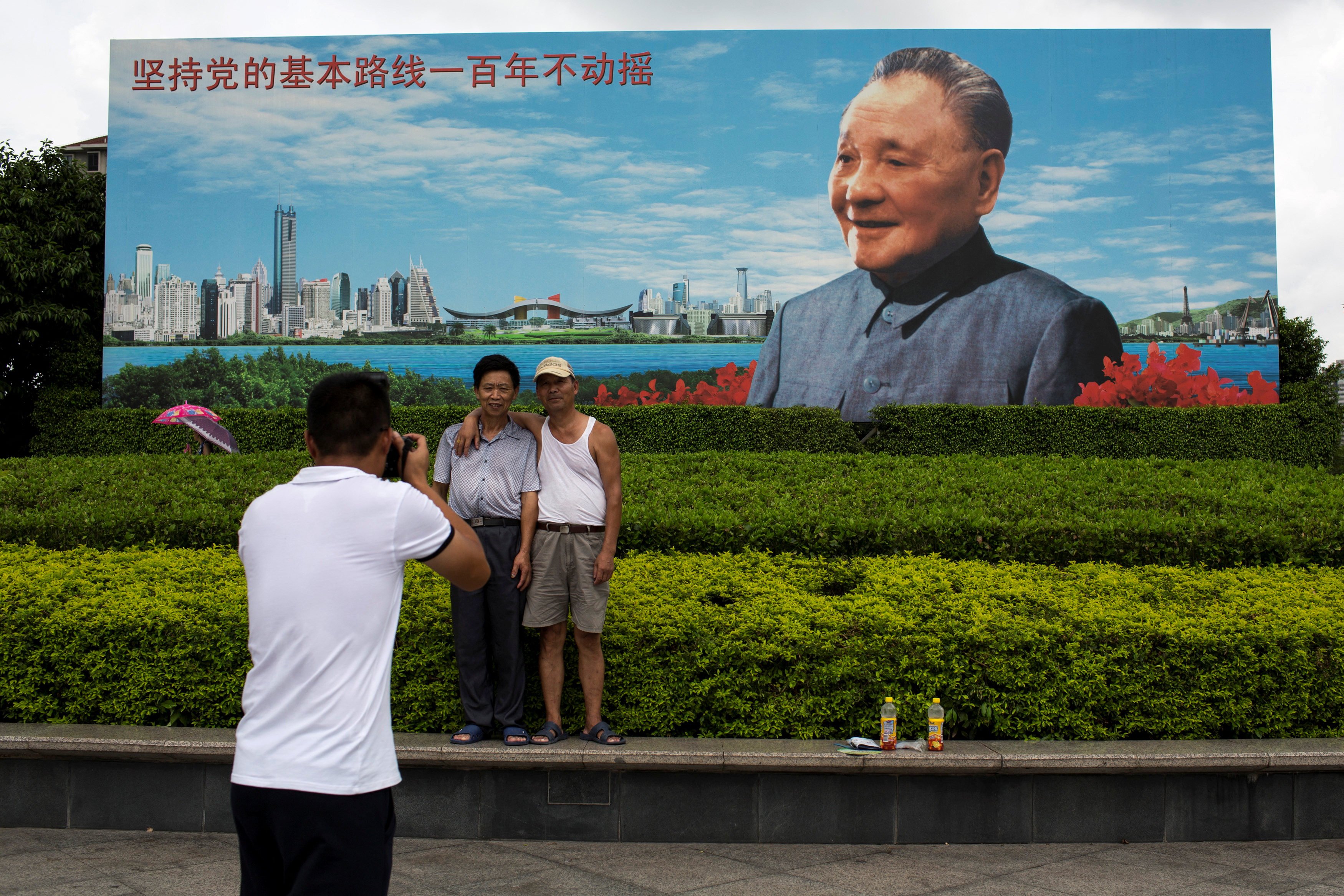 Visitors pose for a picture in front of a billboard of the late Chinese reformist leader Deng Xiaoping in Shenzhen, in southern China’s Guangdong province. Photo: Reuters
