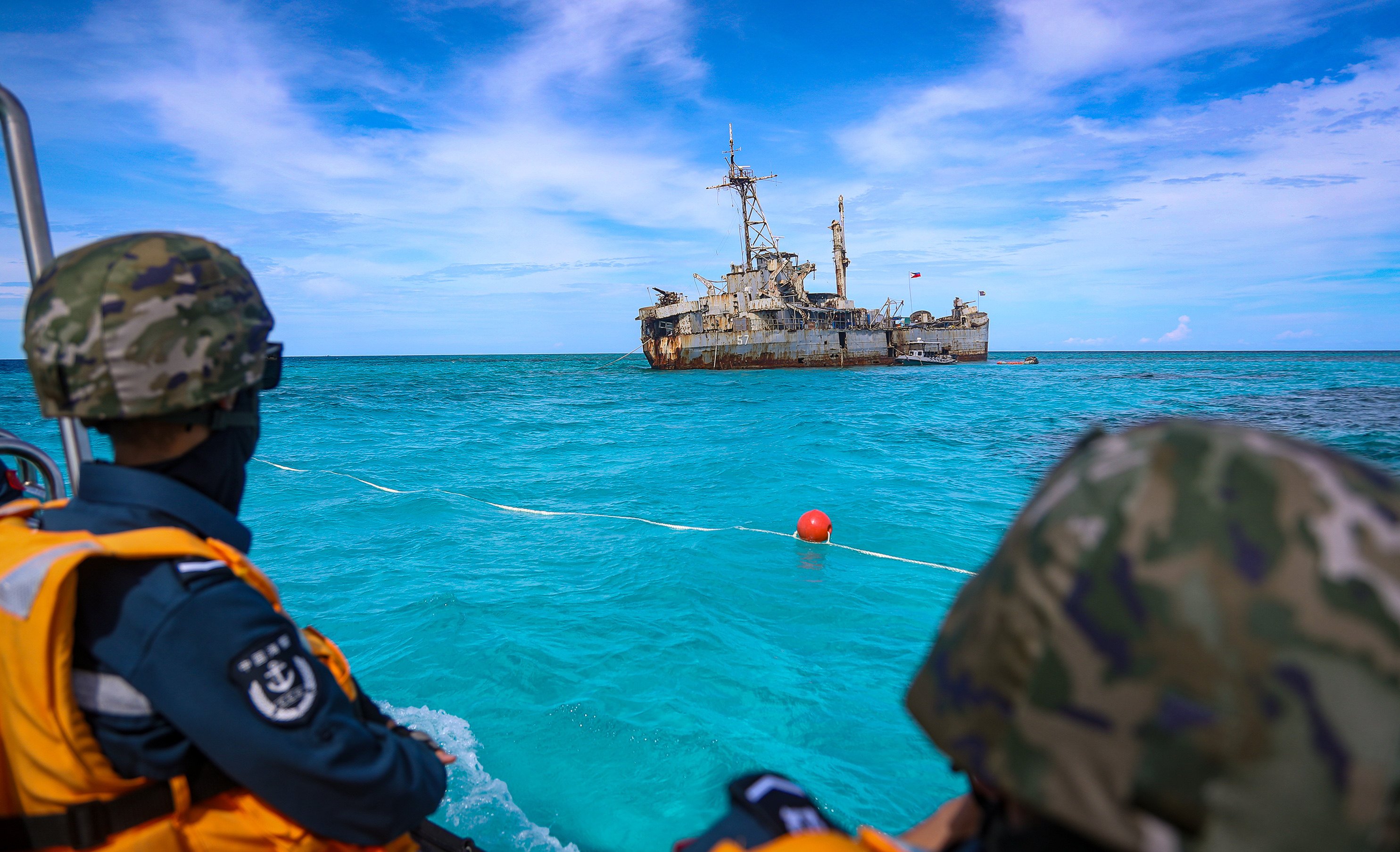 Chinese personnel look at the BRP Sierra Madre, a dilapidated World War II-era Philippine navy vessel grounded at Second Thomas Shoal in the South China Sea. Photo: China Coast Guard/Handout via Xinhua