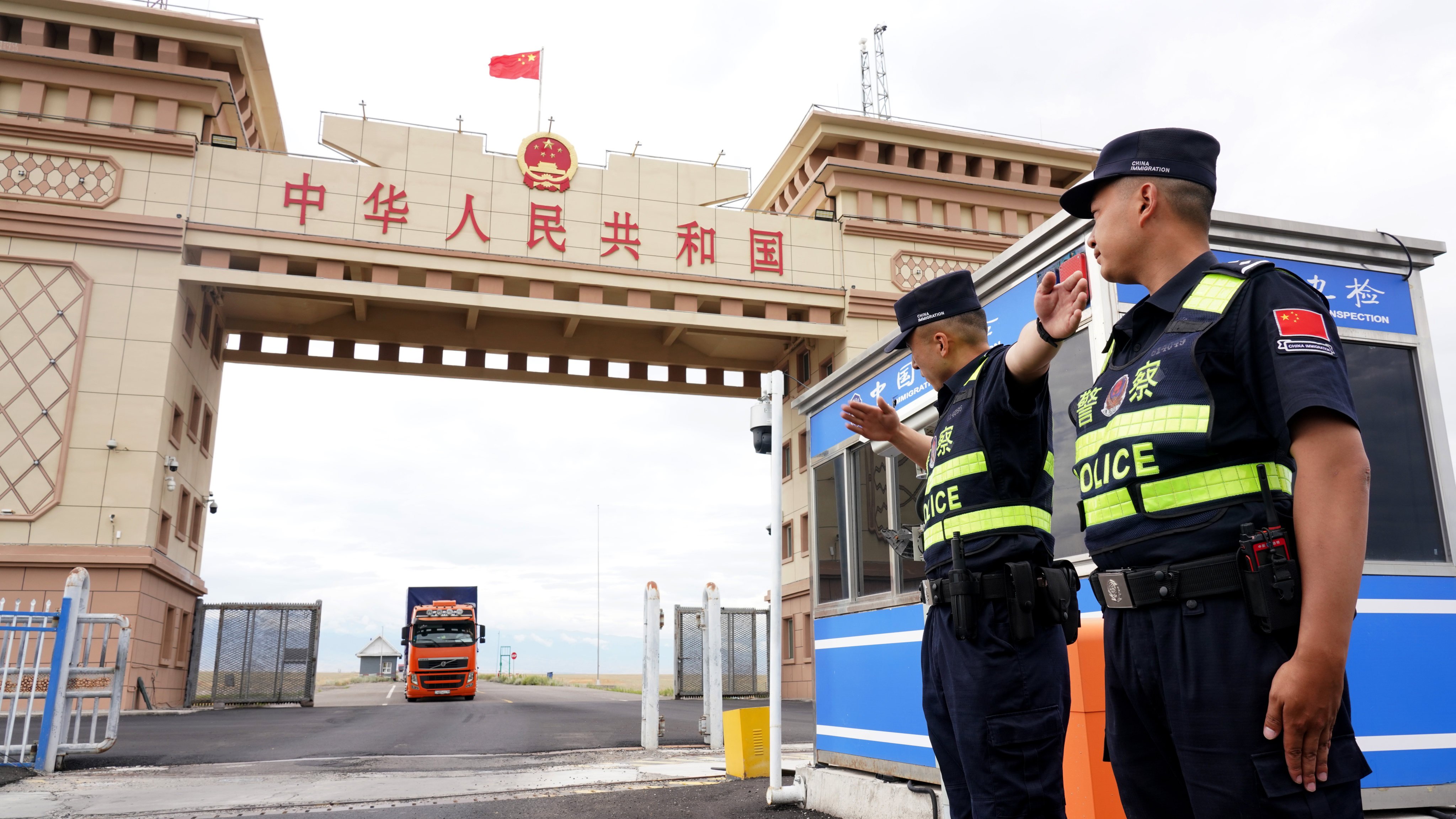 Chinese police officers guide vehicles across the border from Kazakhstan in the Xinjiang Uygur autonomous region in July. Photo: Xinhua