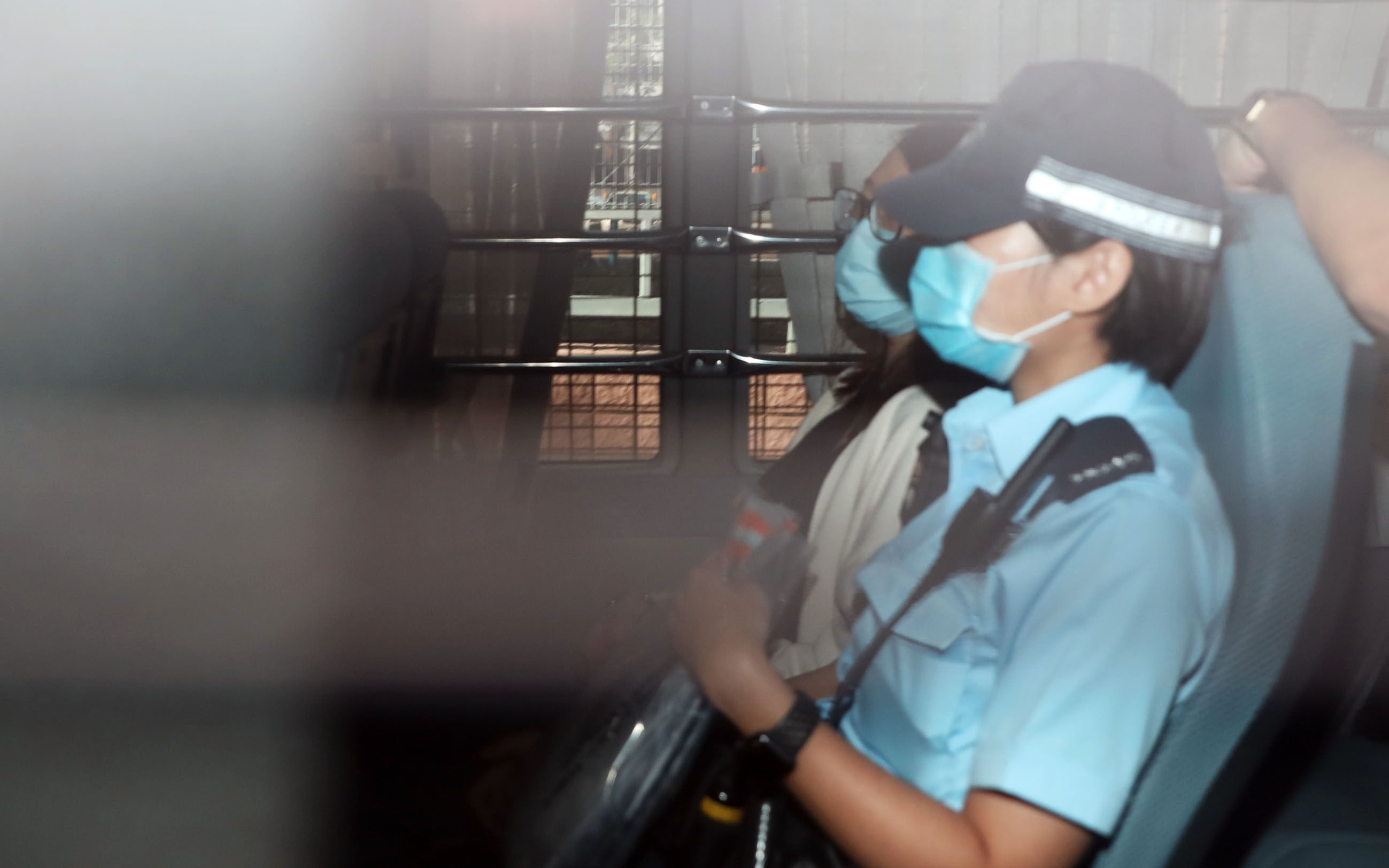 Chung Suet-ying is escorted to the Fanling Court. She was charged over one count of possession of arms or ammunition without licence. Photo: K. Y. Cheng