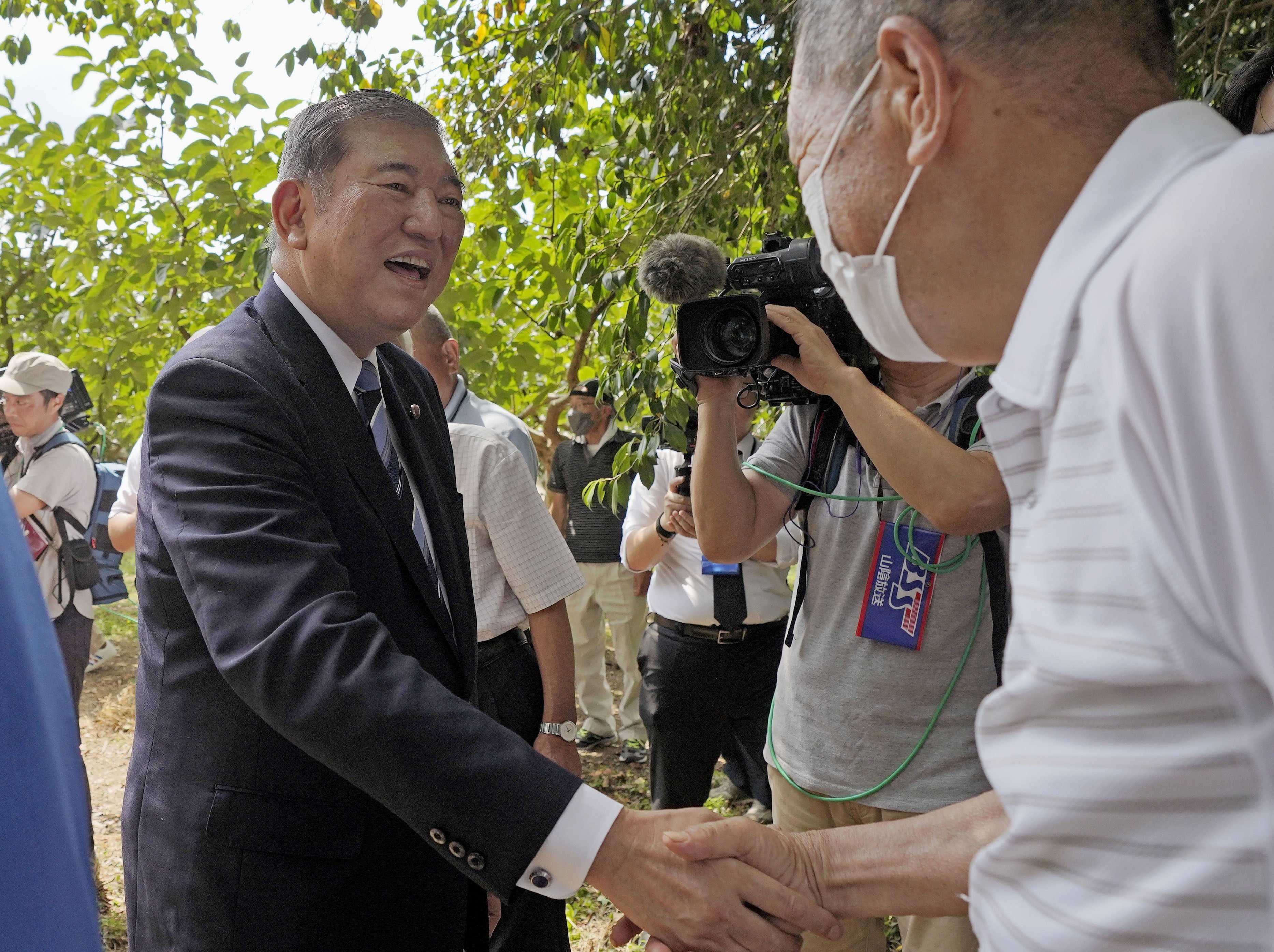 Former Japanese defence minister Shigeru Ishiba shakes hands with a supporter in Yazu, Tottori Prefecture, on August 24. He has announced his candidacy in the ruling party’s leadership race in September. Photo: Kyodo
