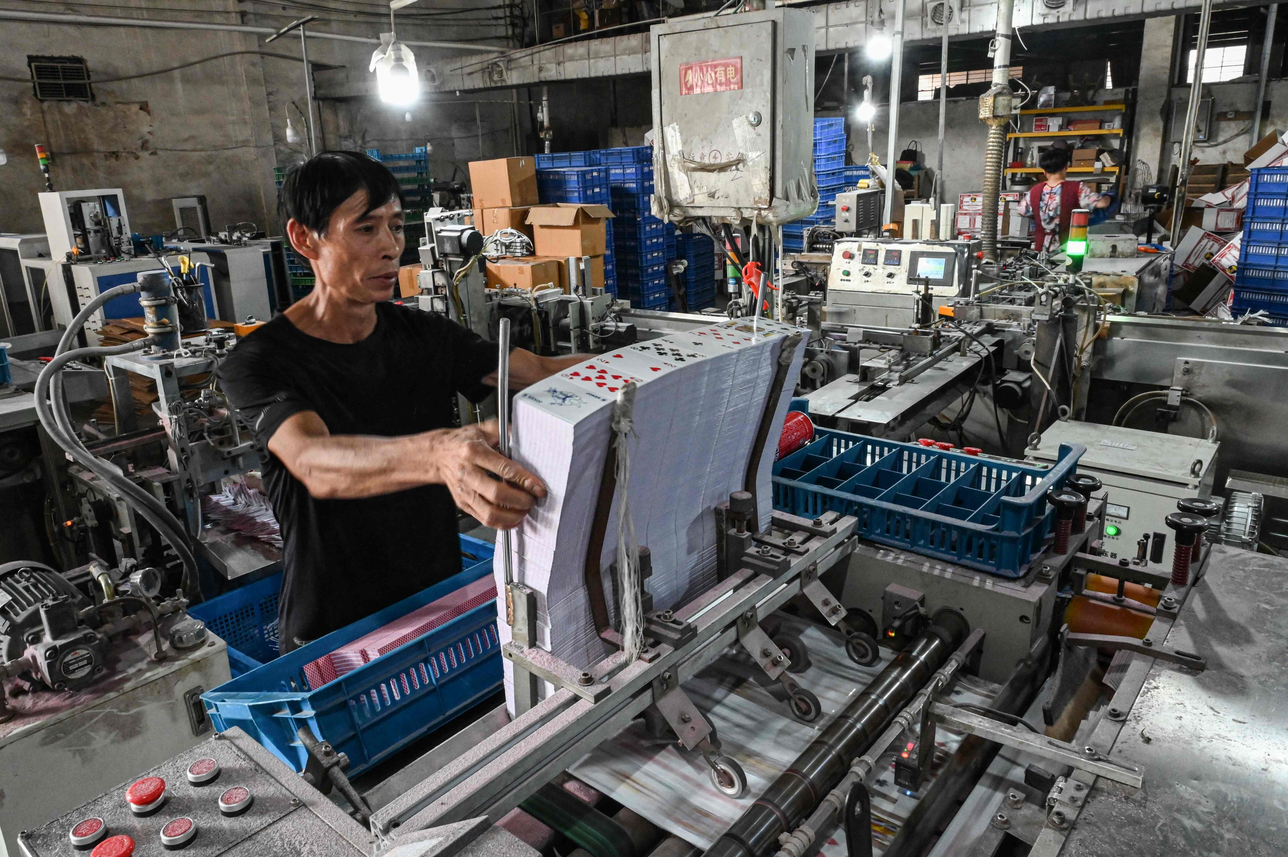 An employee working at a factory that manufactures playing cards in Wuyi, in eastern China’s Zhejiang province. Photo: AFP