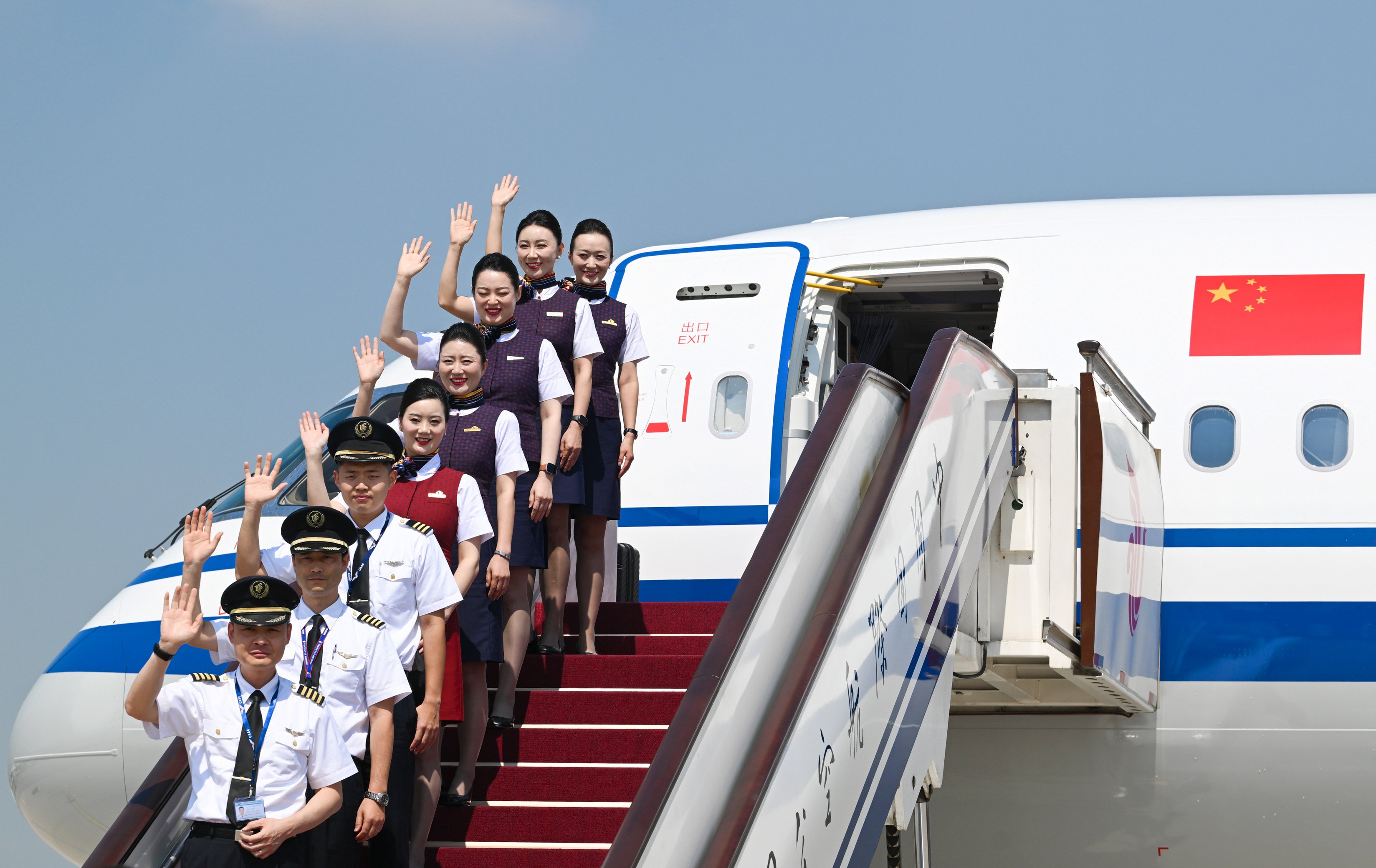 Air China crew pose with the airline’s first C919 jet on Thursday, shortly after its arrival at Beijing Capital International Airport. Photo: Xinhua