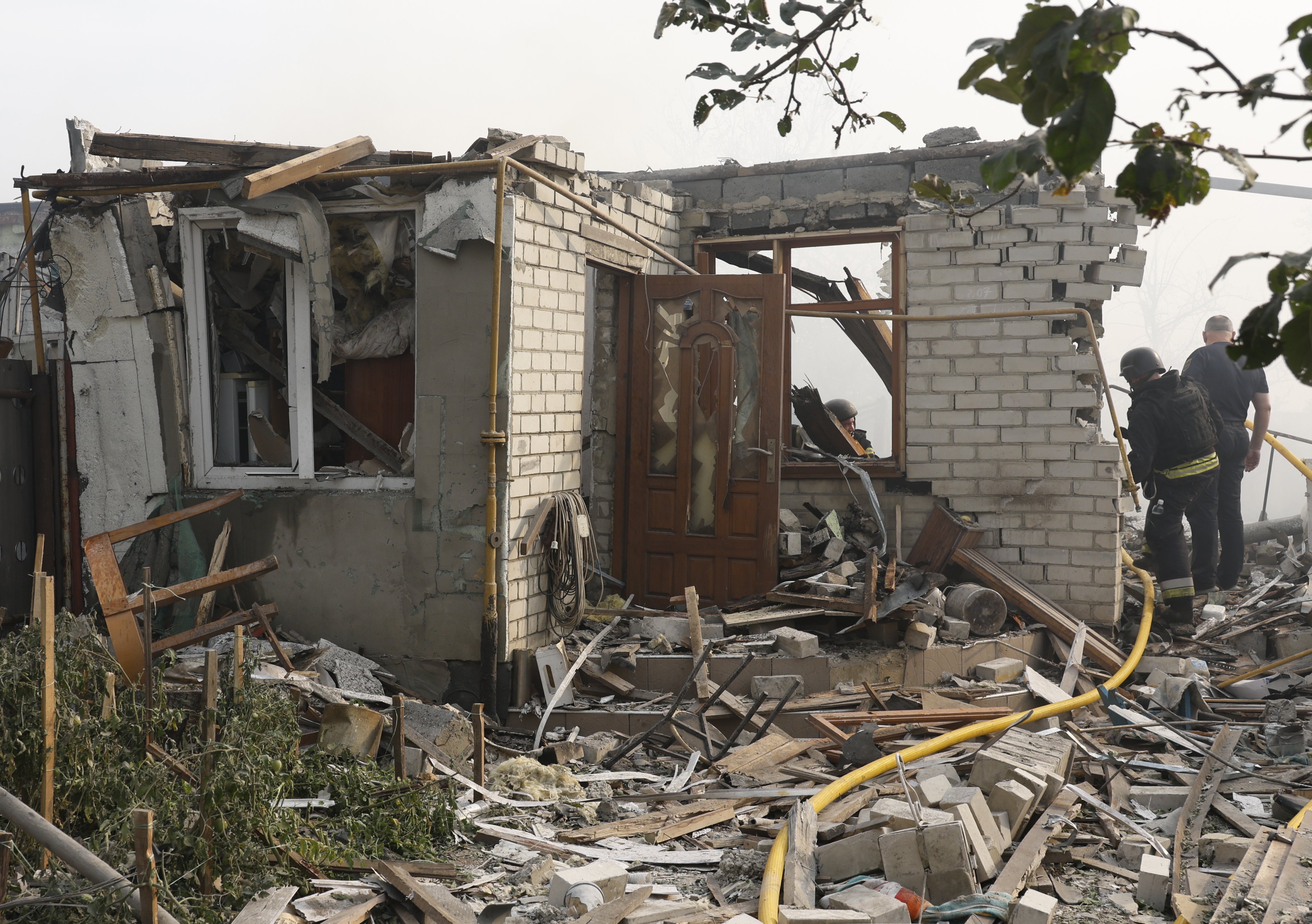 Ukrainian rescuers work at the site of a missile strike in Cherkaska Lozova, Kharkiv region, on Saturday. Photo: EPA-EFE