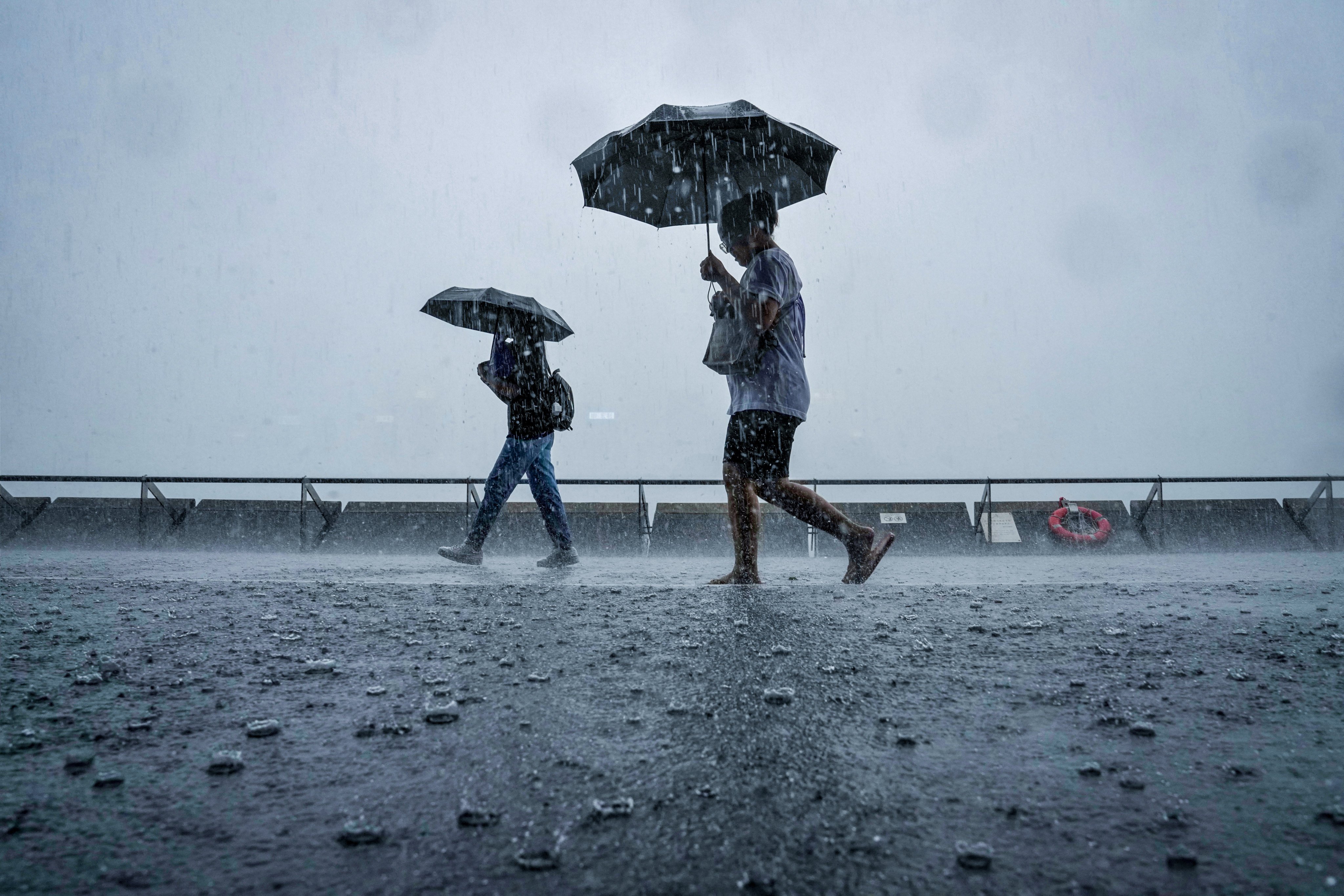 People hang around Tsim Sha Tsui Promenade under No 8 typhoon signal in October 2023. The forecaster is expected to issue the No 1 standby signal on Tuesday. Photo: Elson LI