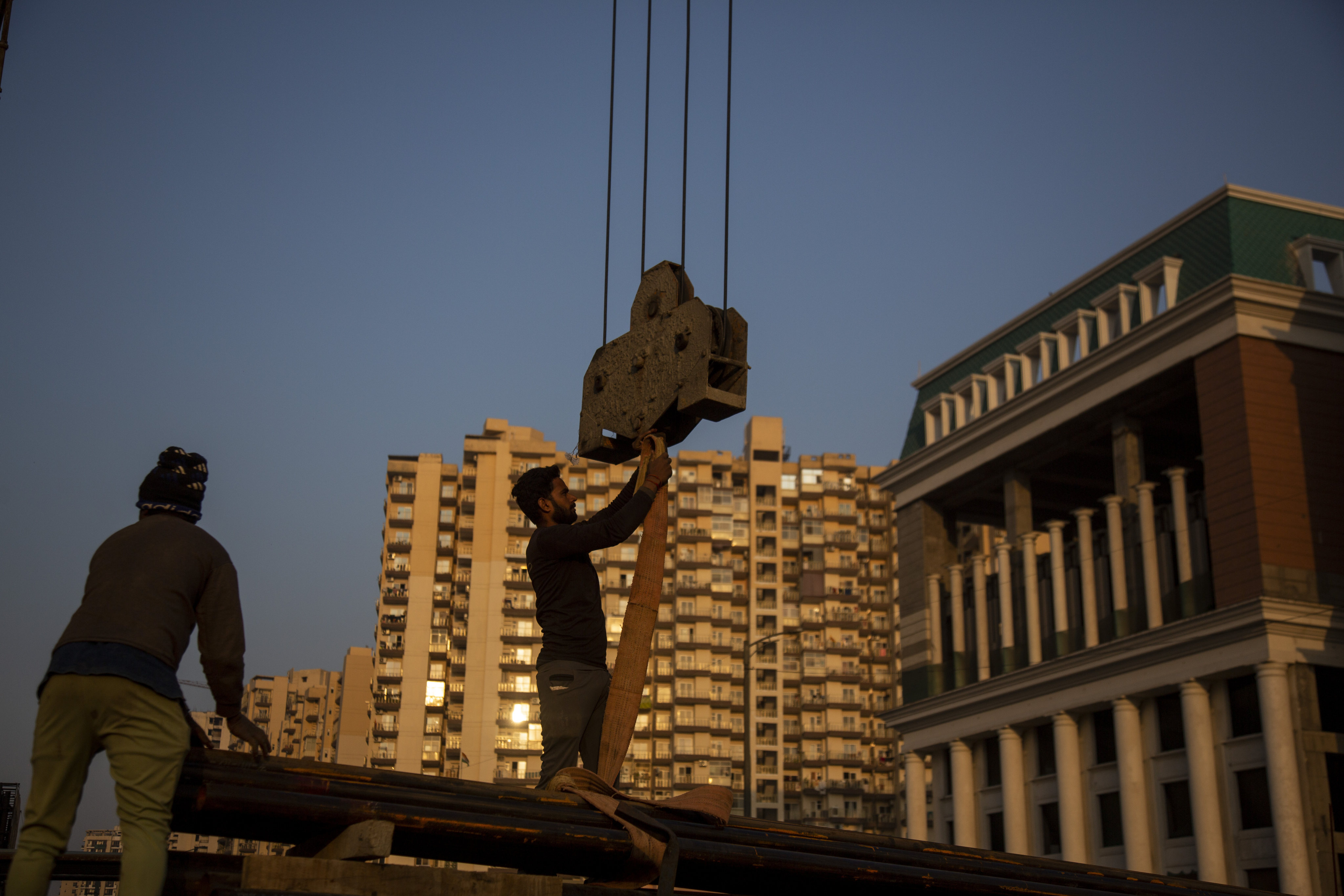 Workers handle building construction material in Greater Noida, Uttar Pradesh, India, on December 7, 2022. India’s property industry is well placed to continue benefiting from resilient growth. Photo: AP