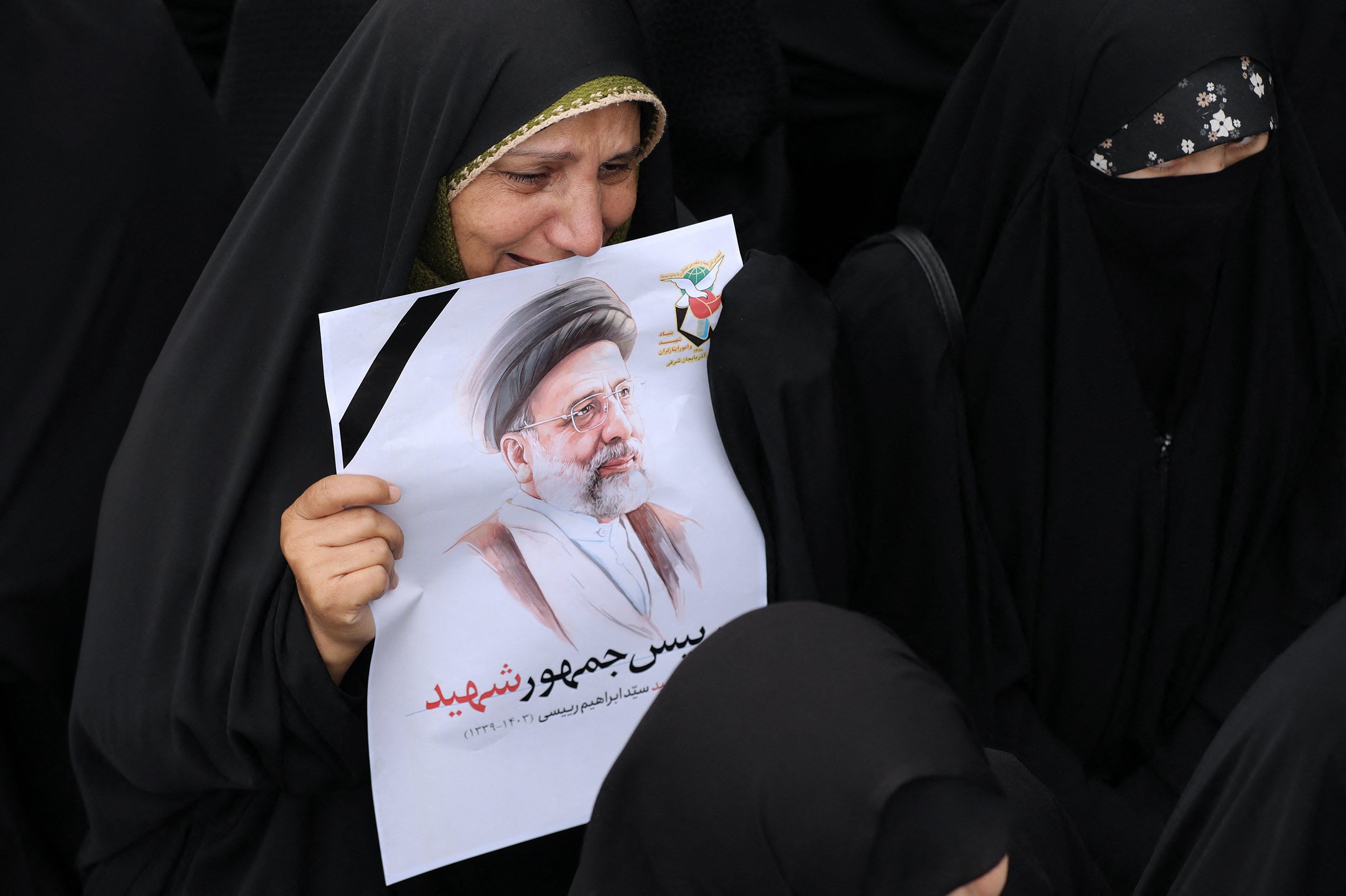 A mourner holds a portrait of late Iranian president Ebrahim Raisi during a funeral procession in Tabriz, the capital of Iran’s East Azerbaijan province, on May 21. Photo: Iranian Presidency / AFP