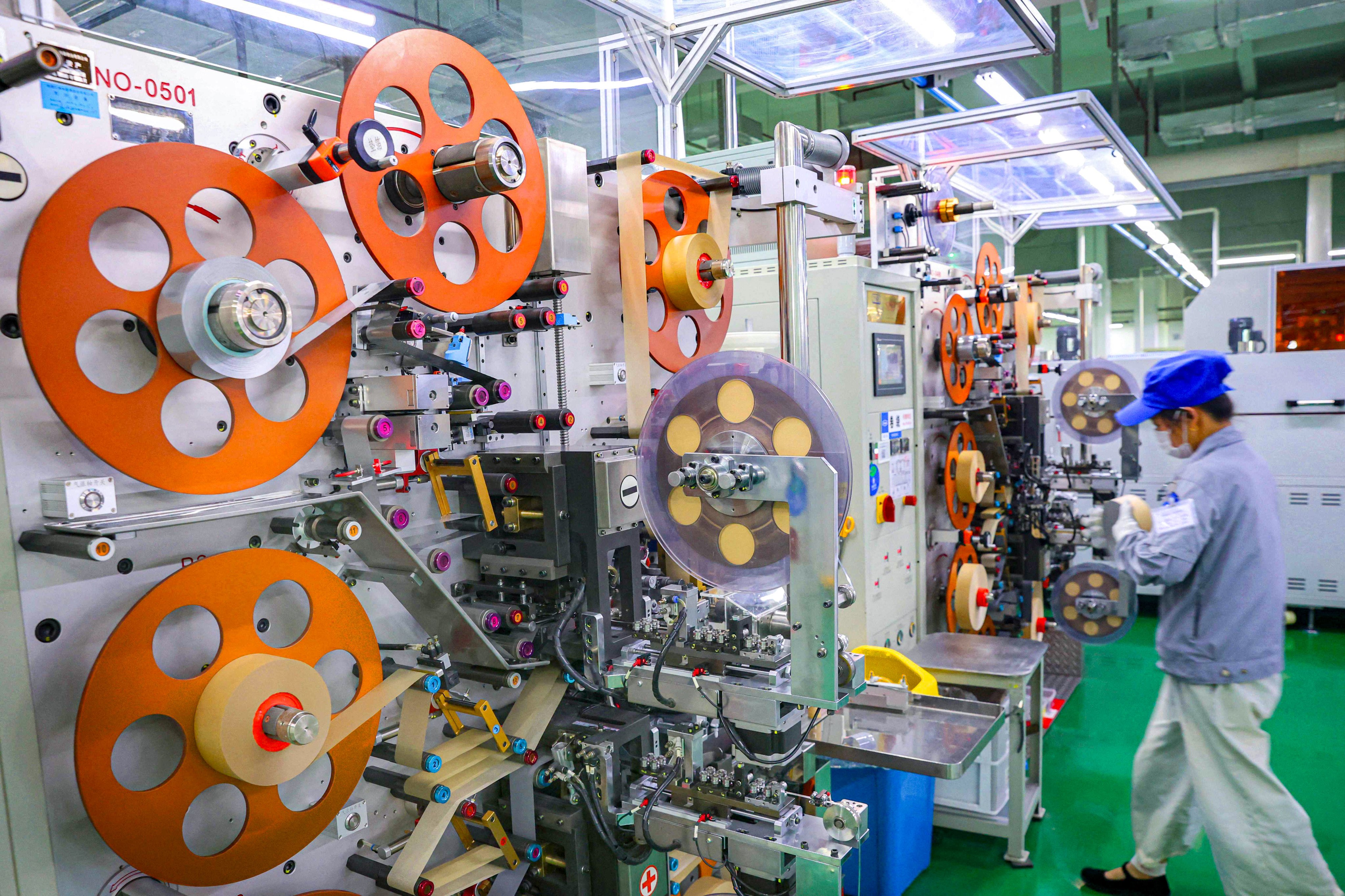 An employee produces electronic components at a factory in Nantong, in eastern China’s Jiangsu province, on August 6, 2024. Photo: AFP