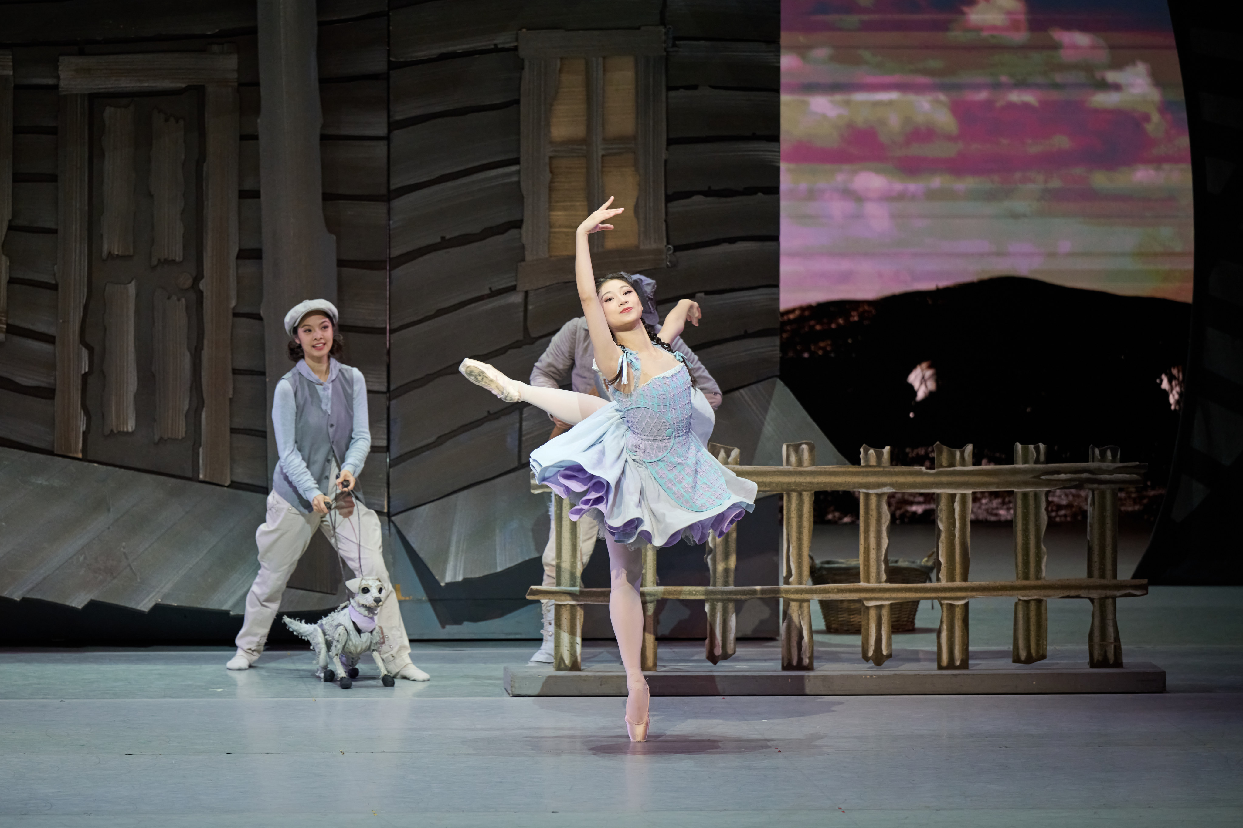 Zoe Loo as Dorothy and Natalie Lu with a puppet of Toto the dog in Hong Kong Ballet’s The Wizard of Oz. Photo: Conrad Dy-Liacco; courtesy of Hong Kong Ballet