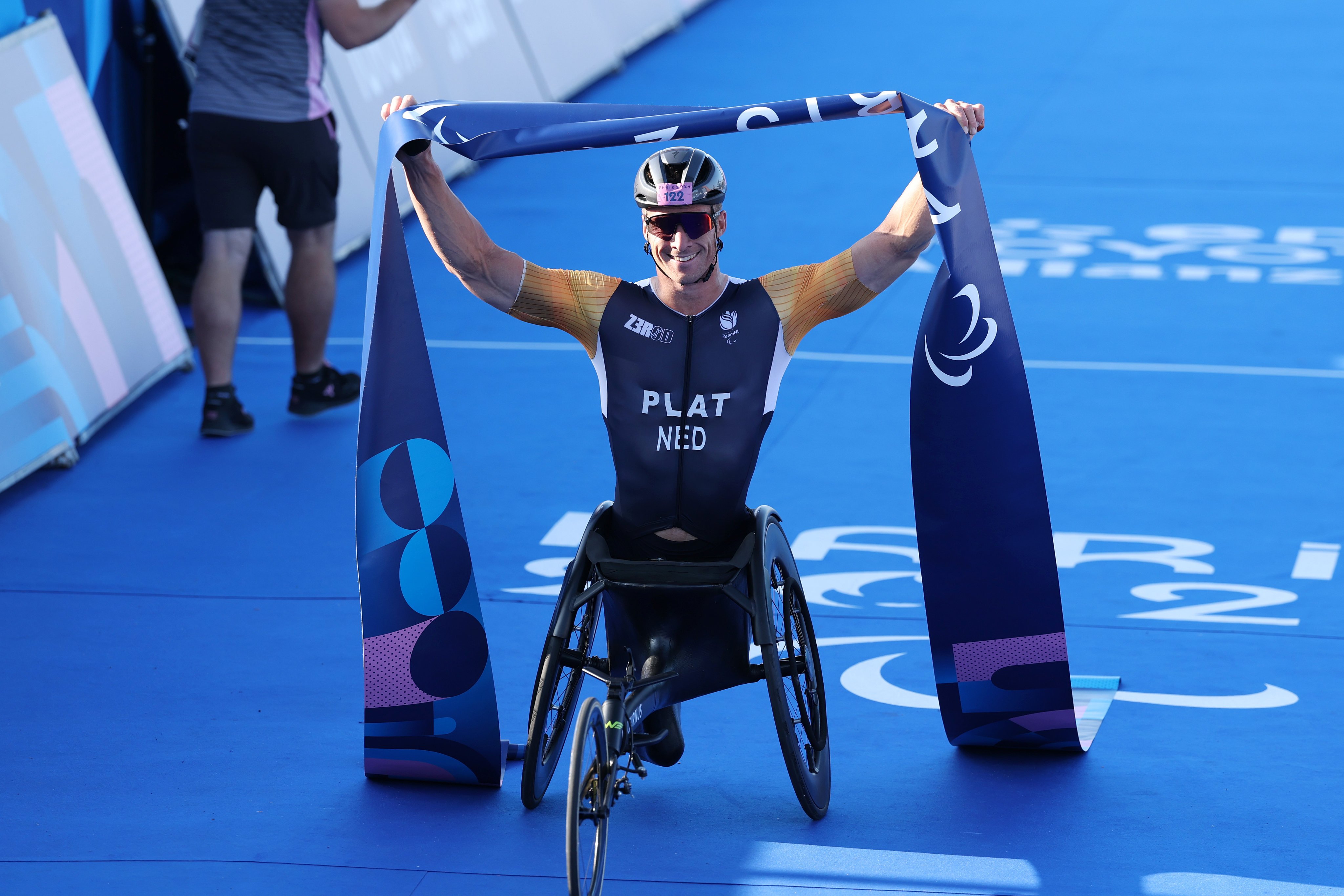 Netherlands’ Jetze Plat celebrates at the finish line after winning the men’s Paralympic triathlon for a third-consecutive Games. Photo: Getty Images