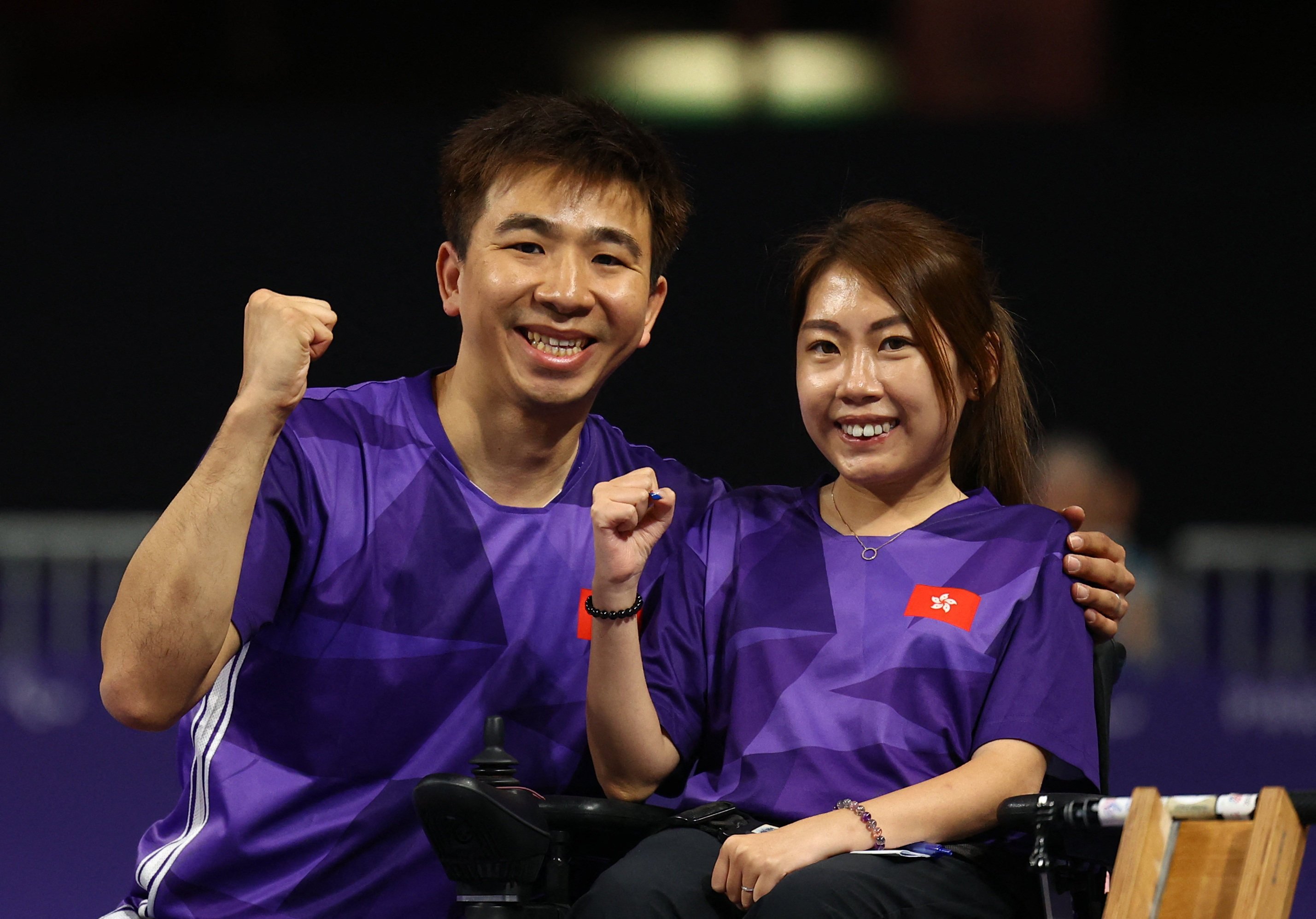 Hong Kong’s Ho Yuen-kei and husband Lee Wing-kit celebrate winning gold at the Paris Paralympics. Photo: Reuters