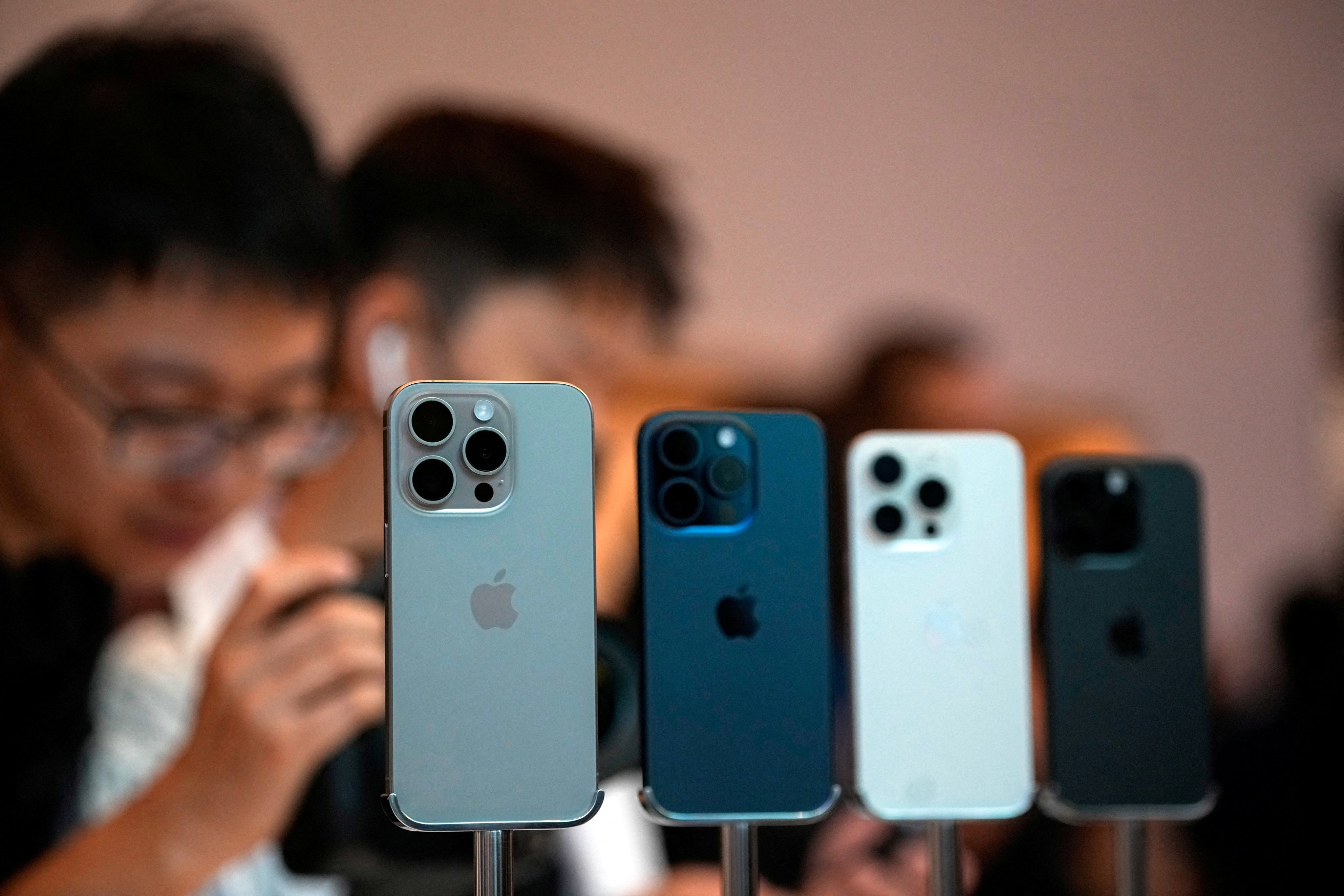 People look at the iPhone 15 Pro after Apple’s smartphone went on sale in Shanghai on September 22, 2023. Photo: Reuters