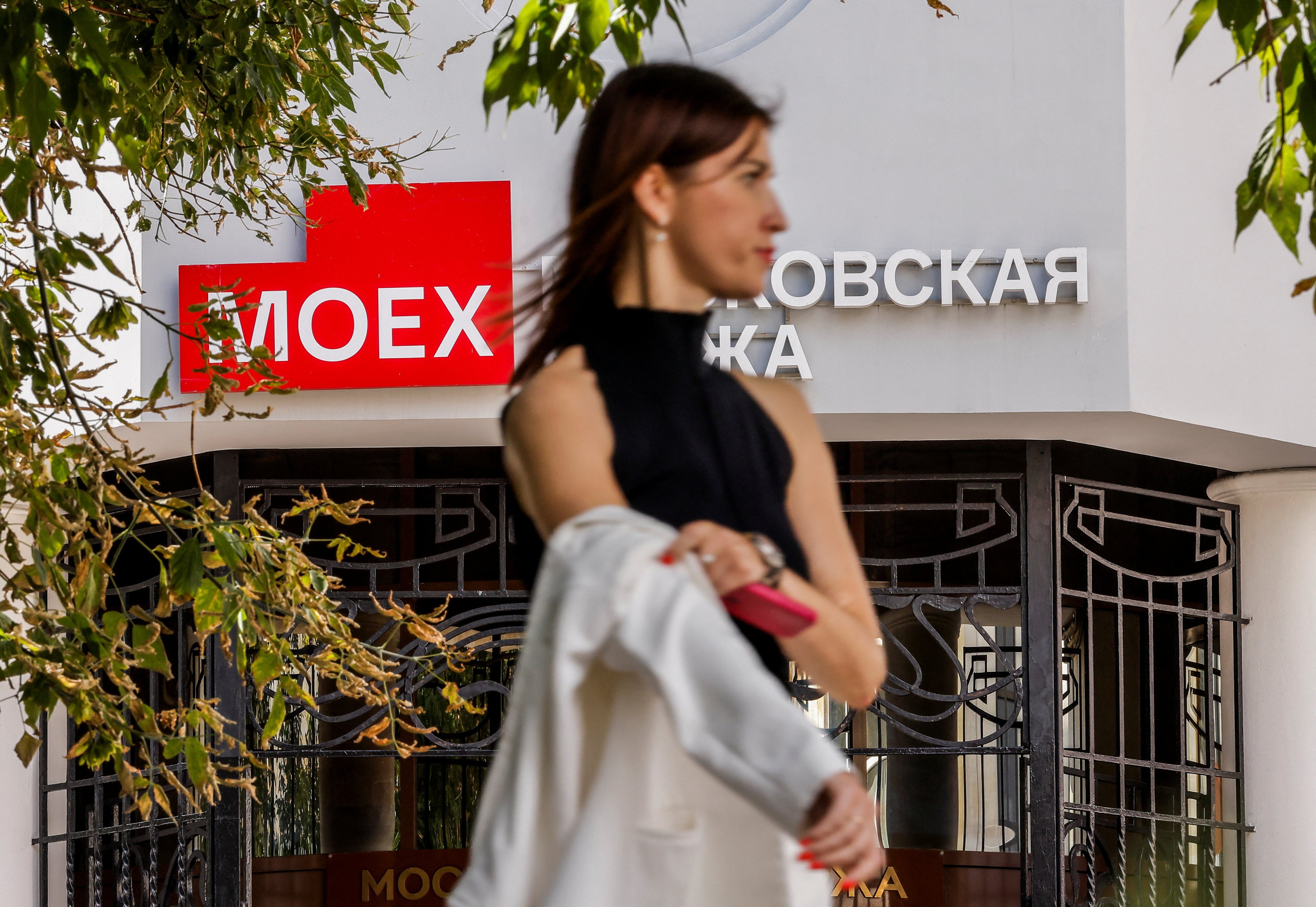 A pedestrian stands in front of an office of the Moscow Exchange, Russia’s leading financial marketplace, on August 5, 2024. Photo: Reuters