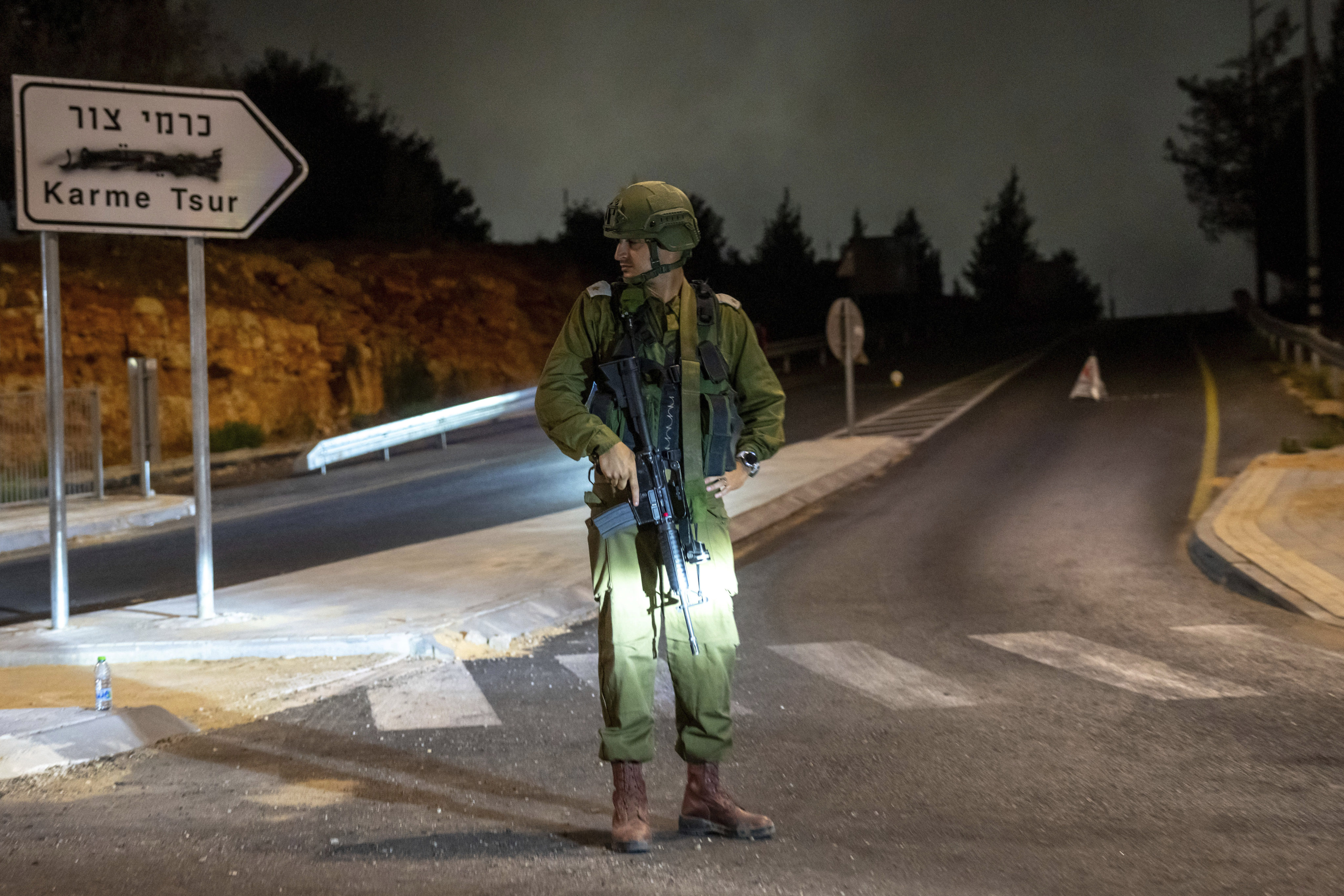 An Israeli soldier stands guard in the West Bank settlement of Karme Tsur on Saturday. Photo: AP