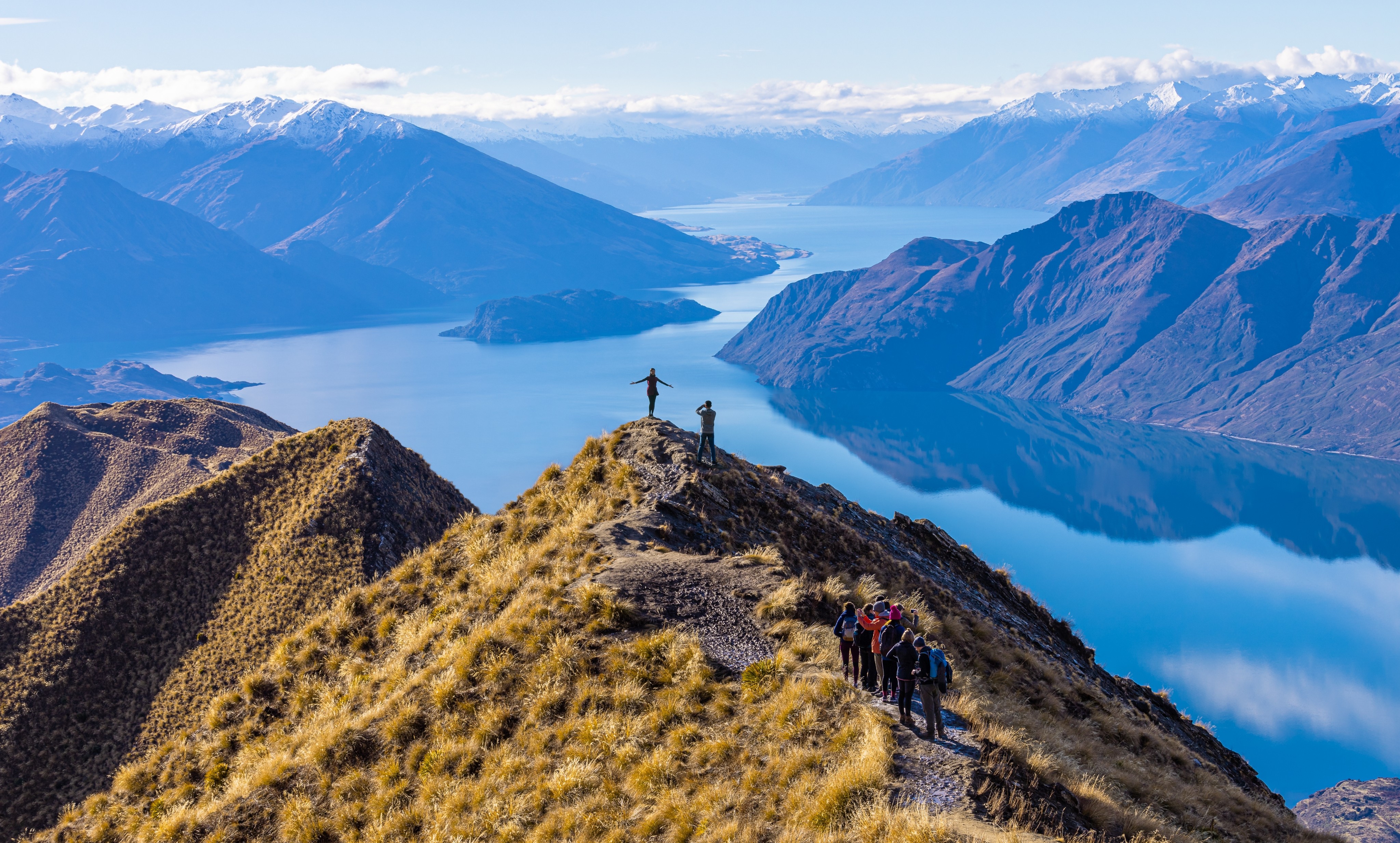 Tourists take photos atop Roy’s Peak at Lake Wanaka in New Zealand. Photo: Shutterstock