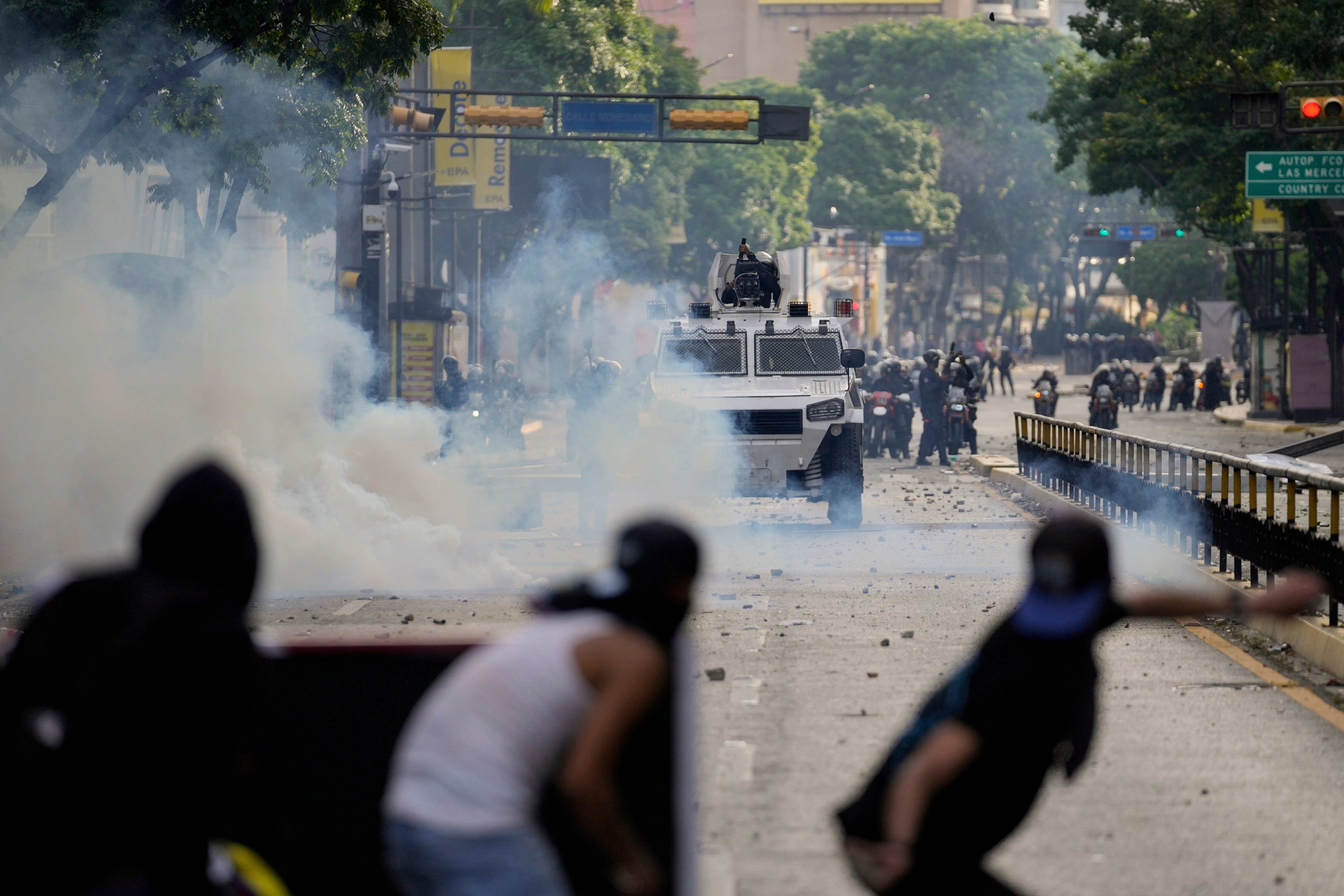 Protesters clash with police over the official election results declaring President Nicolas Maduro’s reelection, the day after the vote in Caracas, Venezuela. Photo: AP