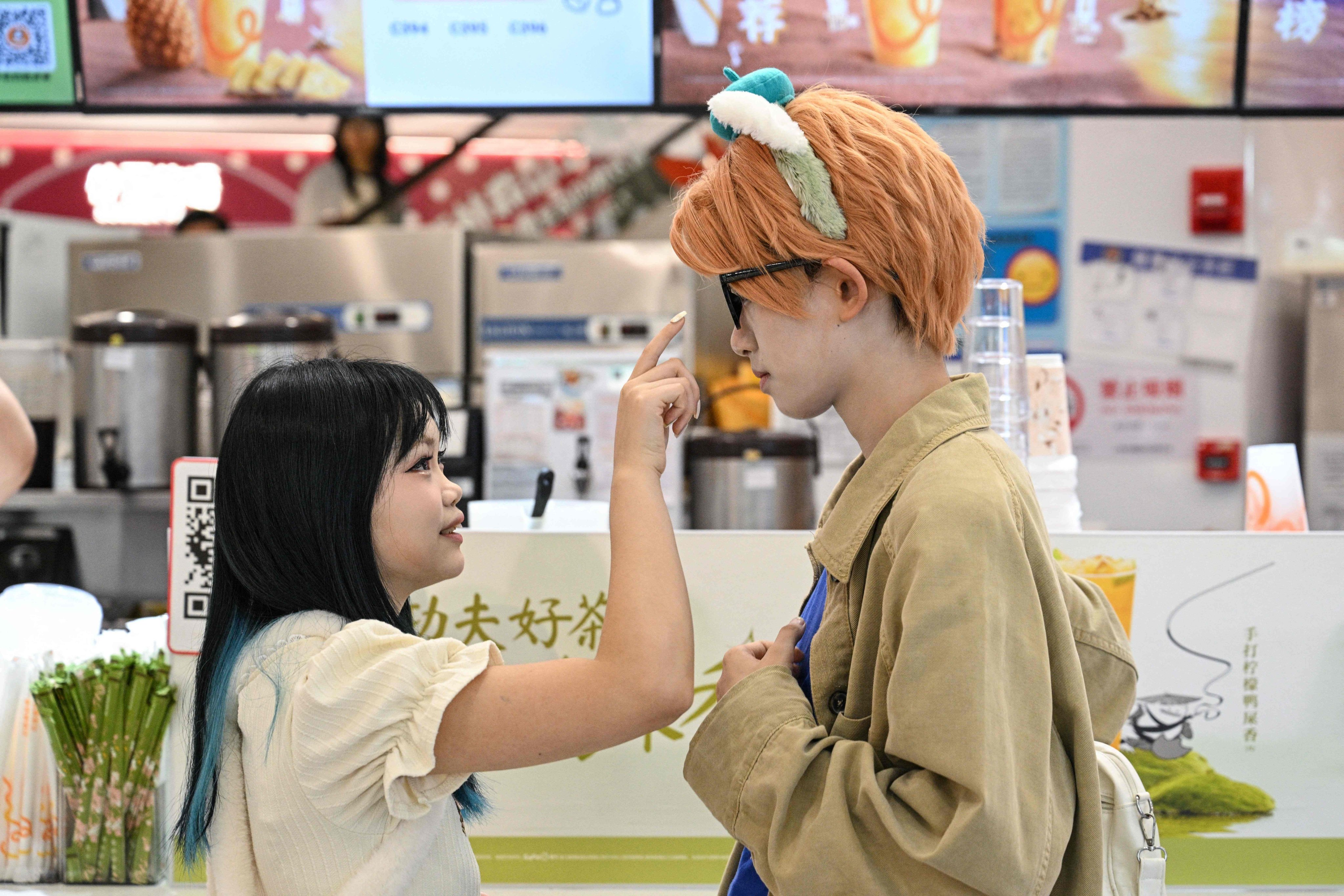 Cosplayer Xu Yunting (right), dressed as a male character from a video game, and client Feng Xinyu during a “cos commissioning” date in Shanghai. Photo: AFP