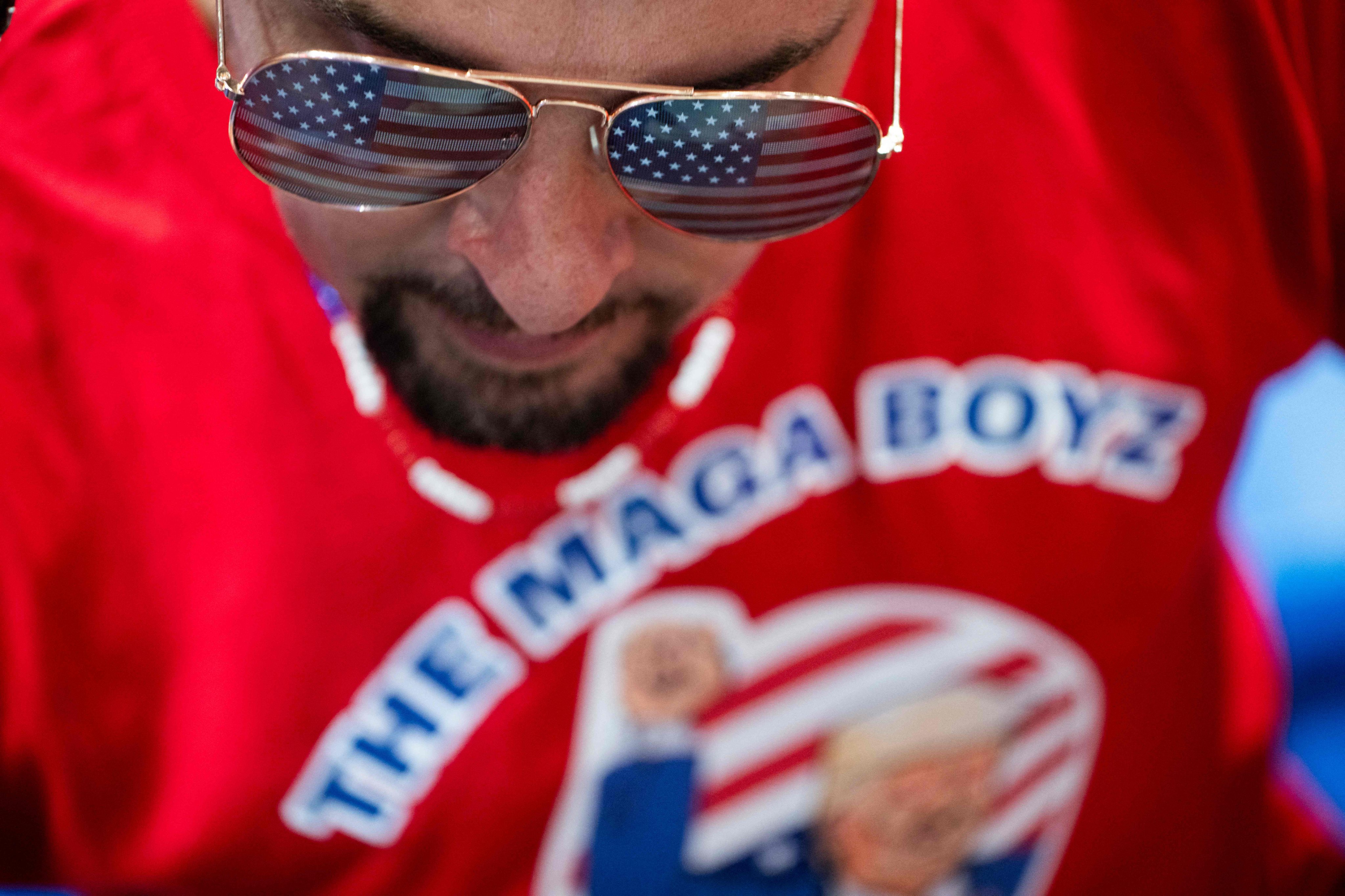 A tattooed millennial cryptocurrency investor wears a Maga Boyz T-shirt during a Trump rally last month. Photo: AFP