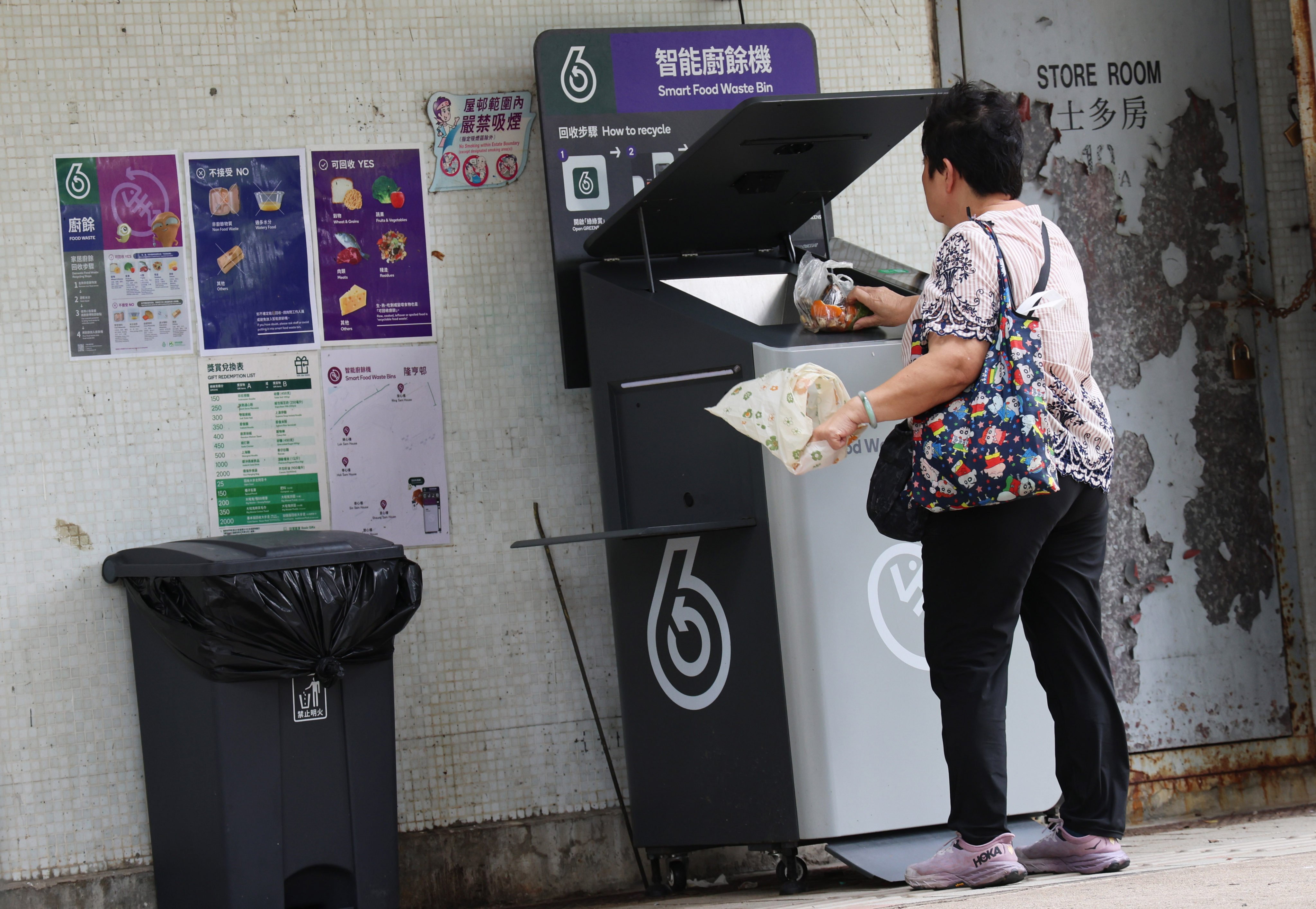 A resident uses a food waste bin at Lung Hang Estate in Sha Tin on May 24. Photo: Jelly Tse