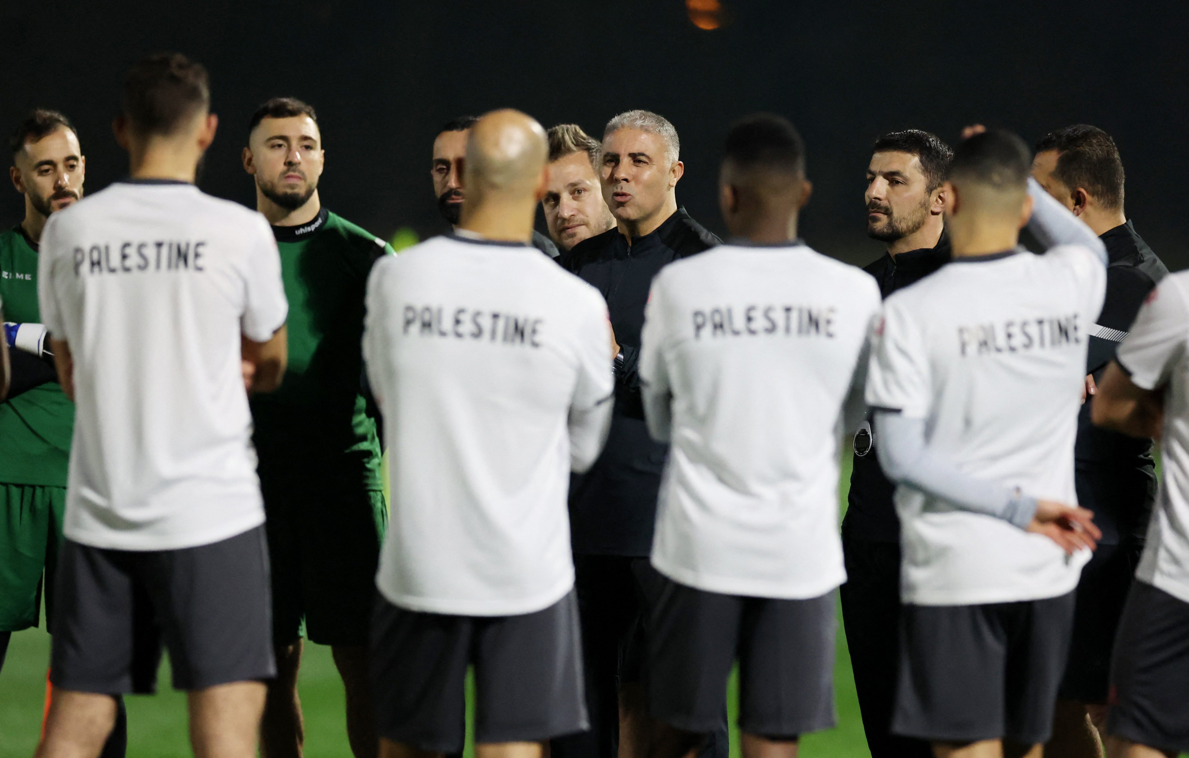 Palestine coach Makram Daboub speaks to his players during a training session in Doha. Photo: Reuters