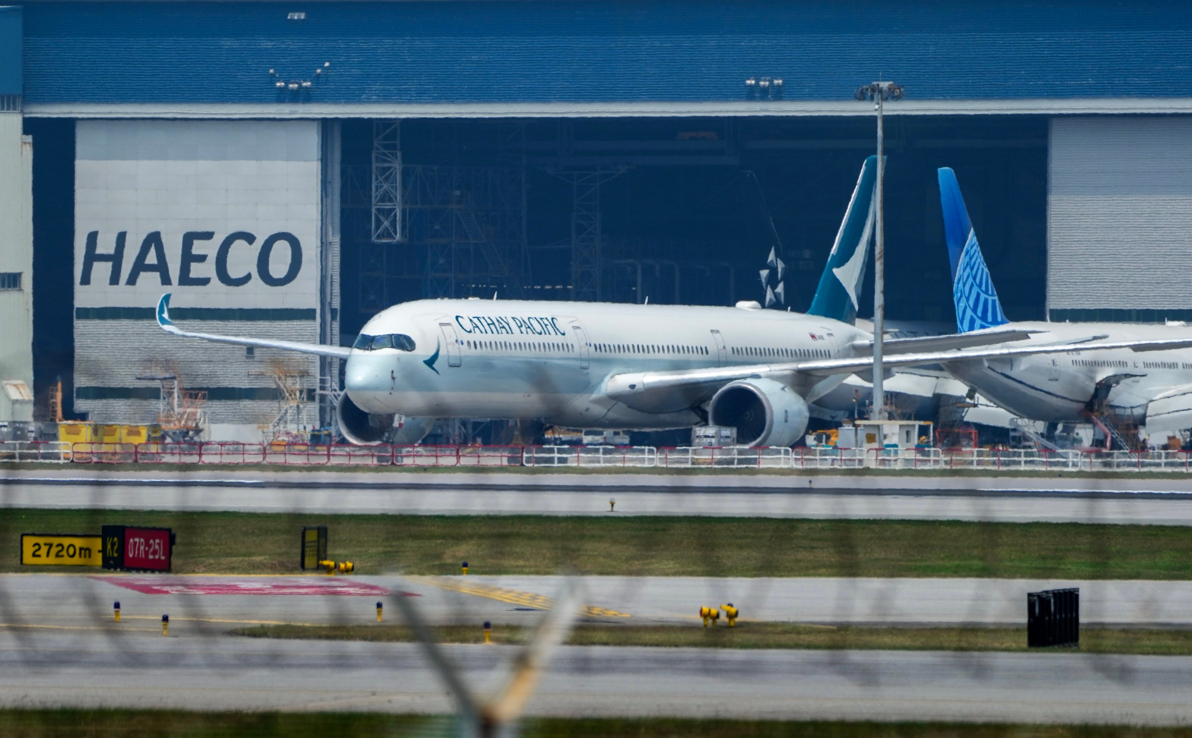 A Cathay Pacific Airbus A350 is parked outside a hanger at Hong Kong International Airport. Photo: Sam Tsang