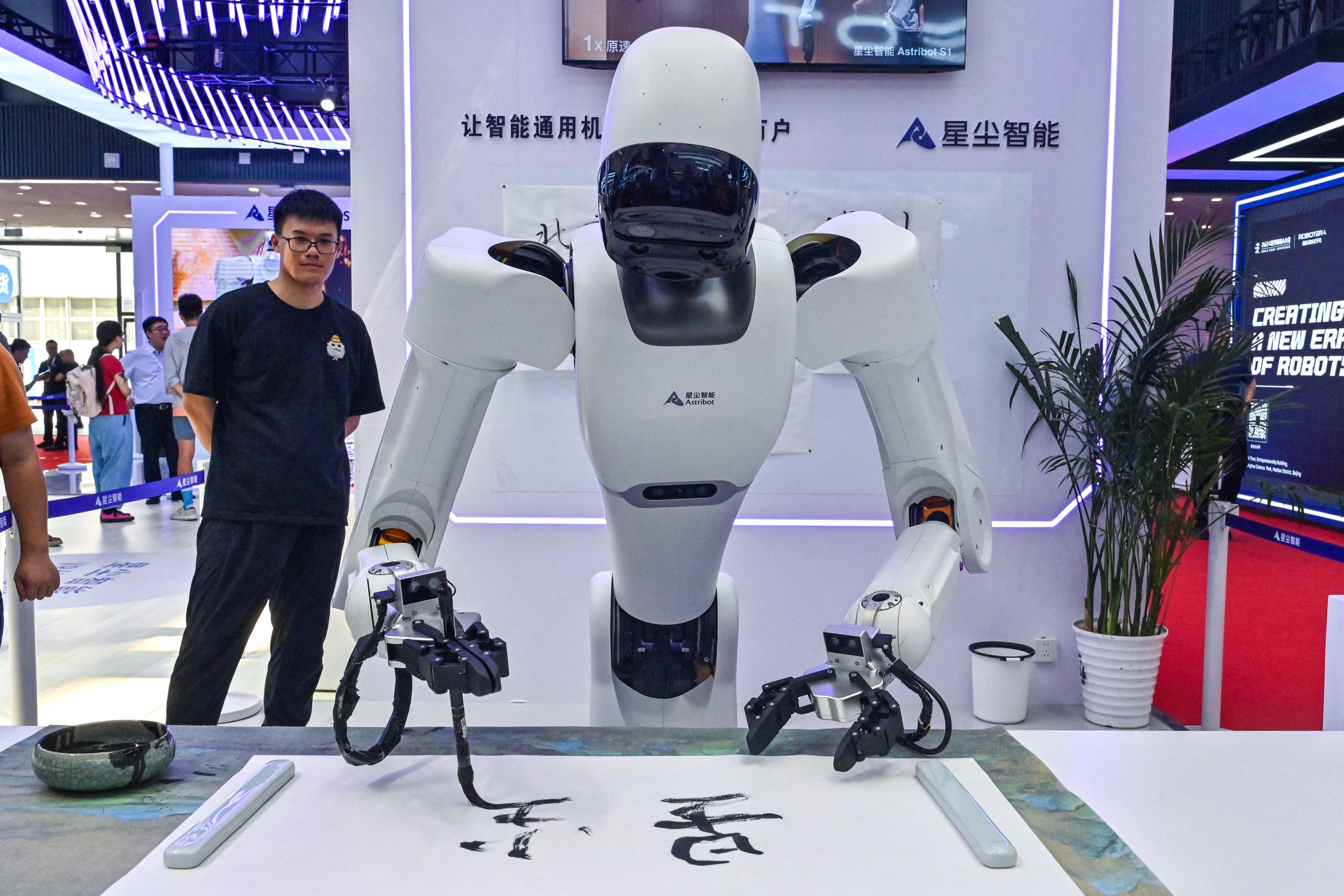 A robot that can write Chinese characters is seen during the World Robot Conference in Beijing. Photo: AFP