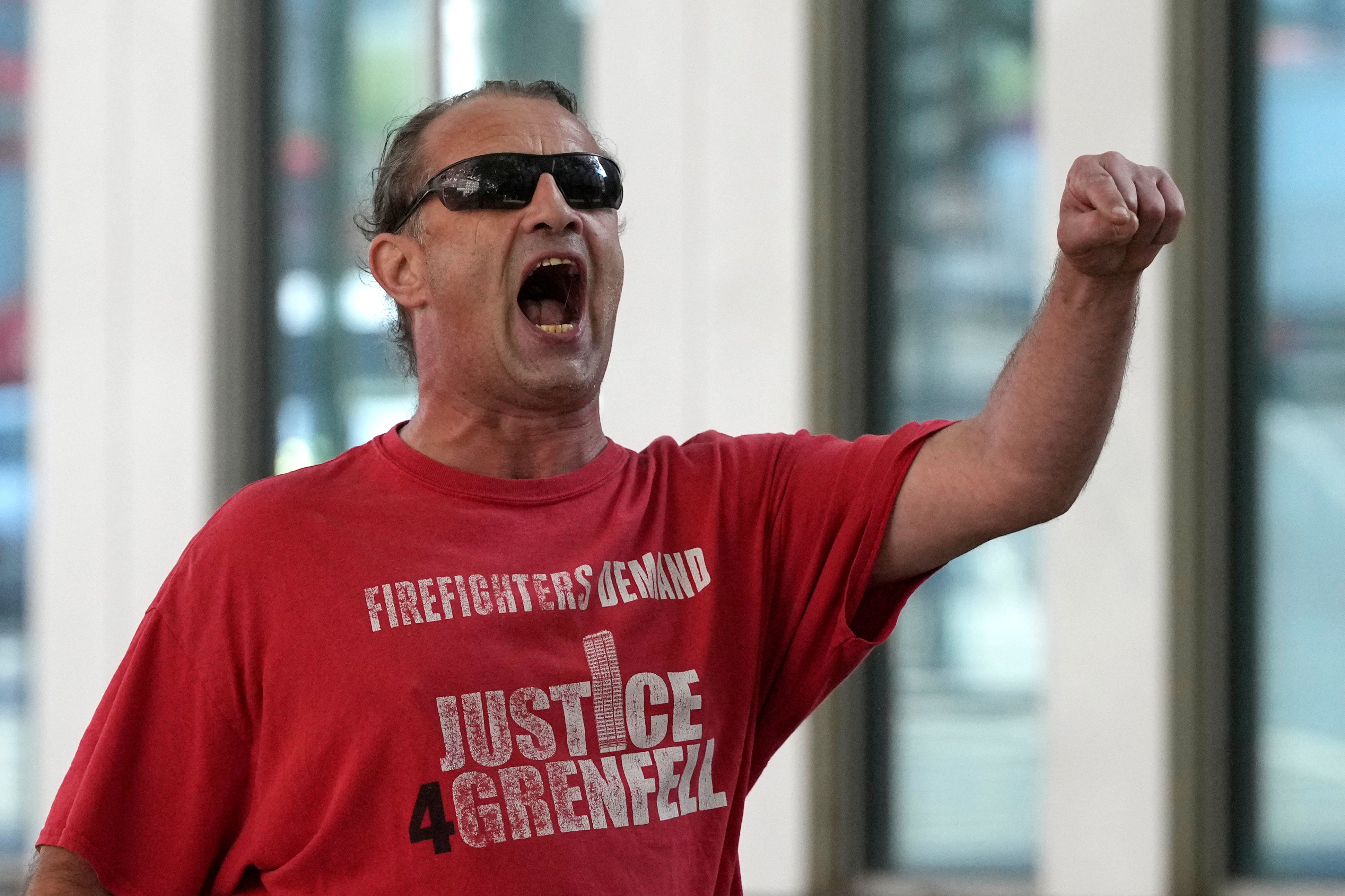 A man attends a protest outside the Grenfell Tower inquiry in London. Photo: AP