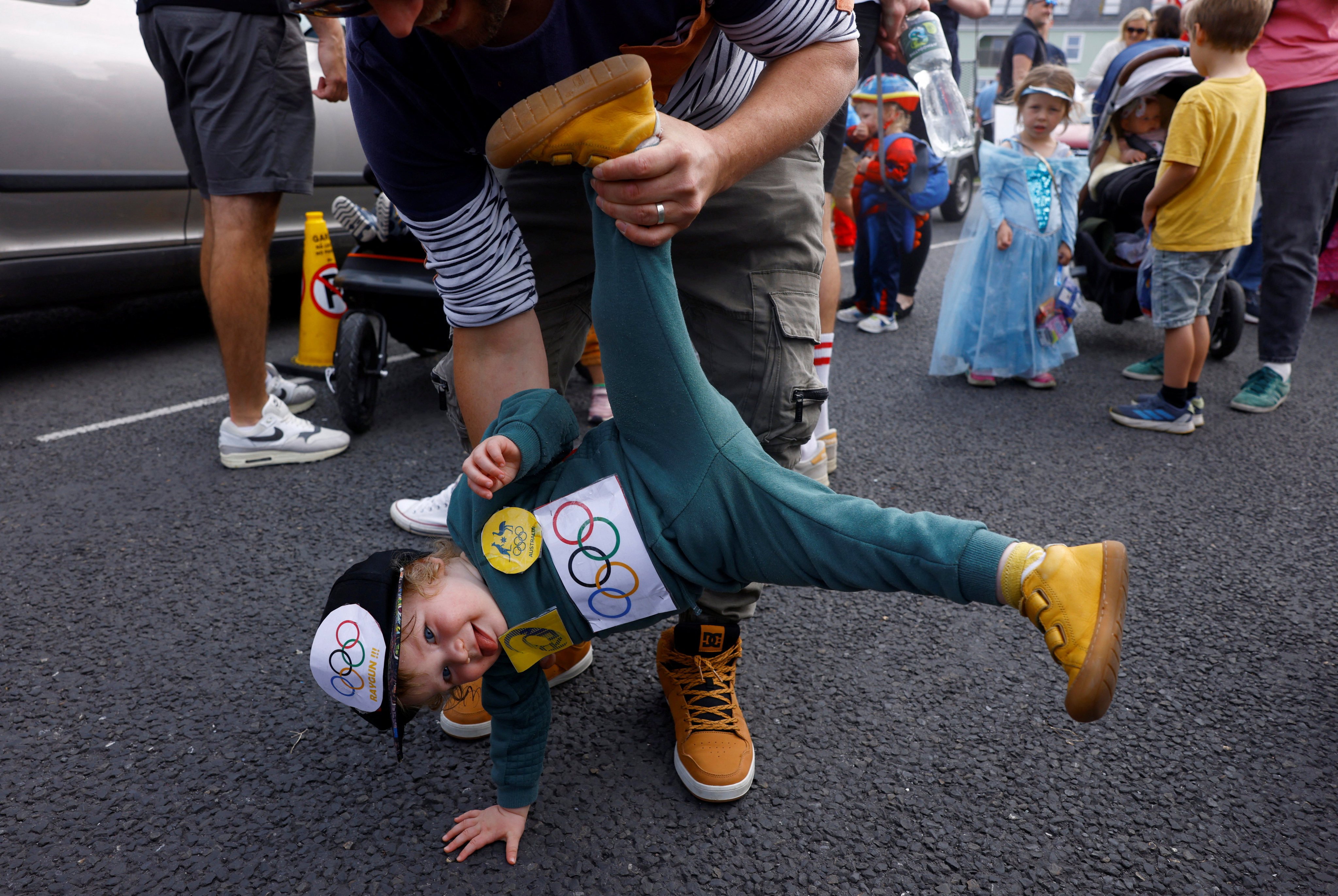 Brodie White, 1, dressed as Raygun, is held by his father at a children’s fancy dress parade in Kinvara, Ireland. Photo: Reuters