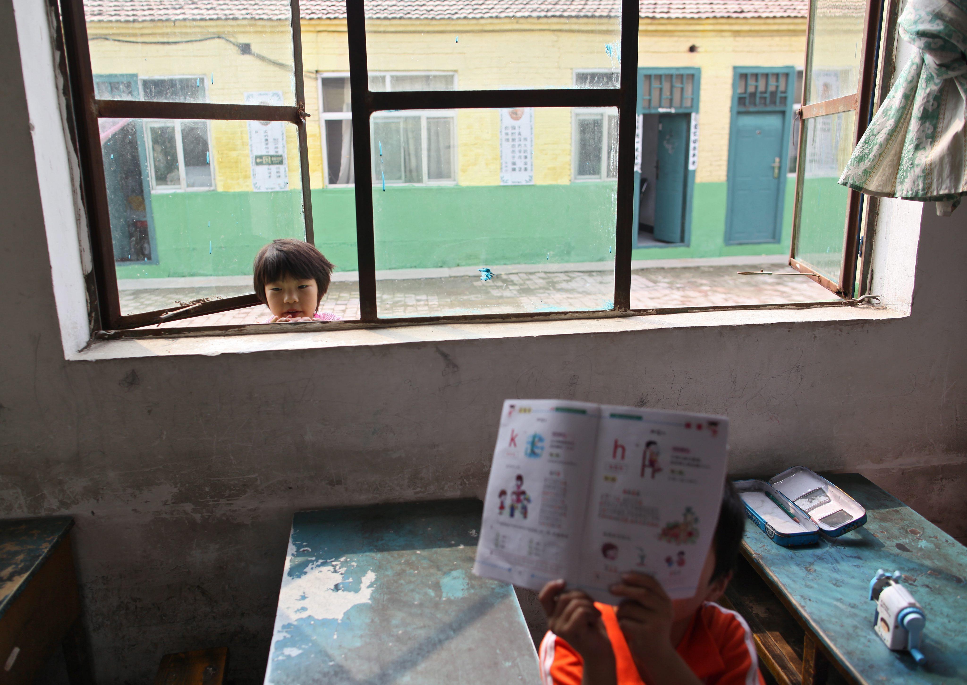 China is compiling a database of children whose parents leave their hometown for long stretches in search of work. Photo: EPA