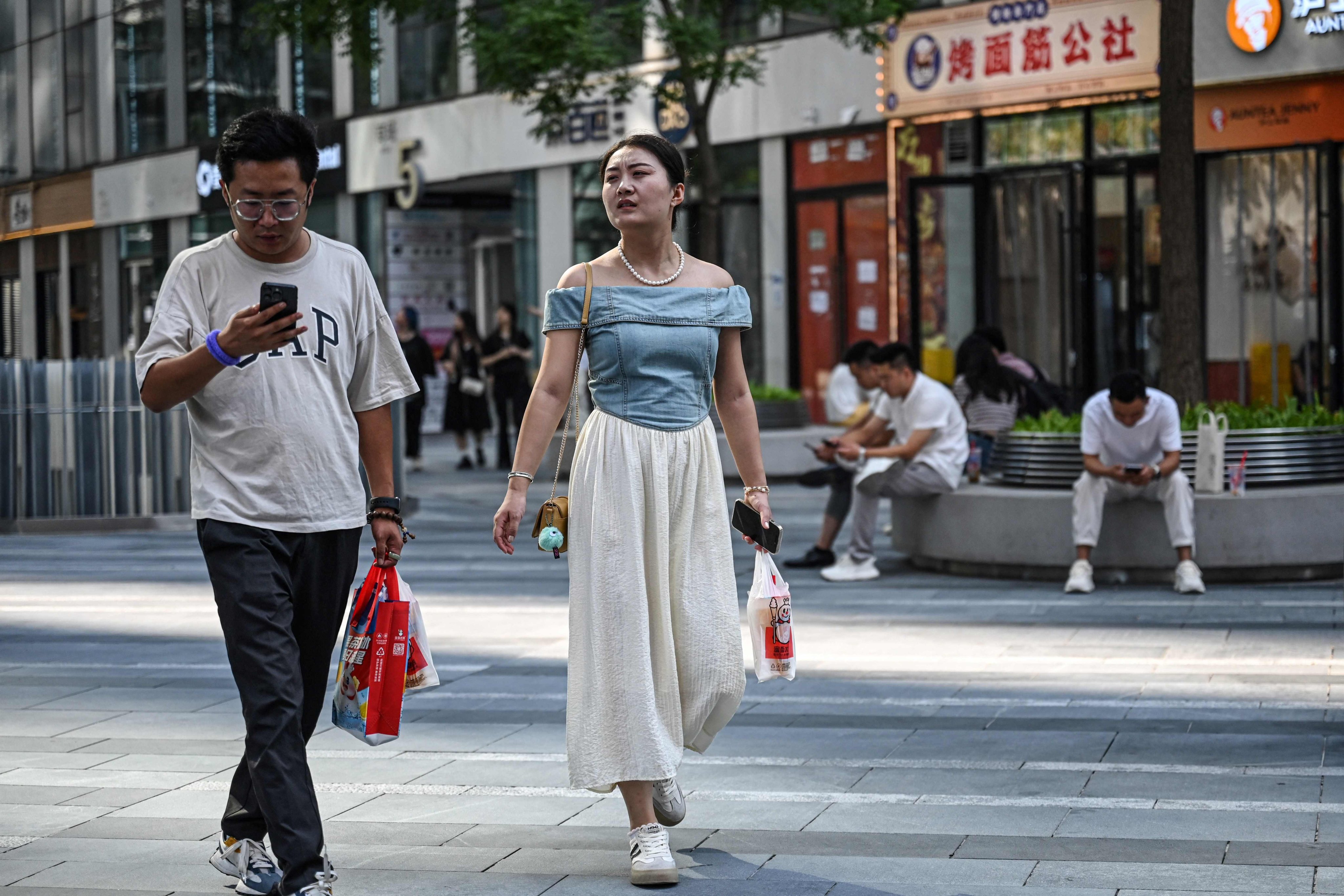 People outside an office building in Beijing. Photo: AFP