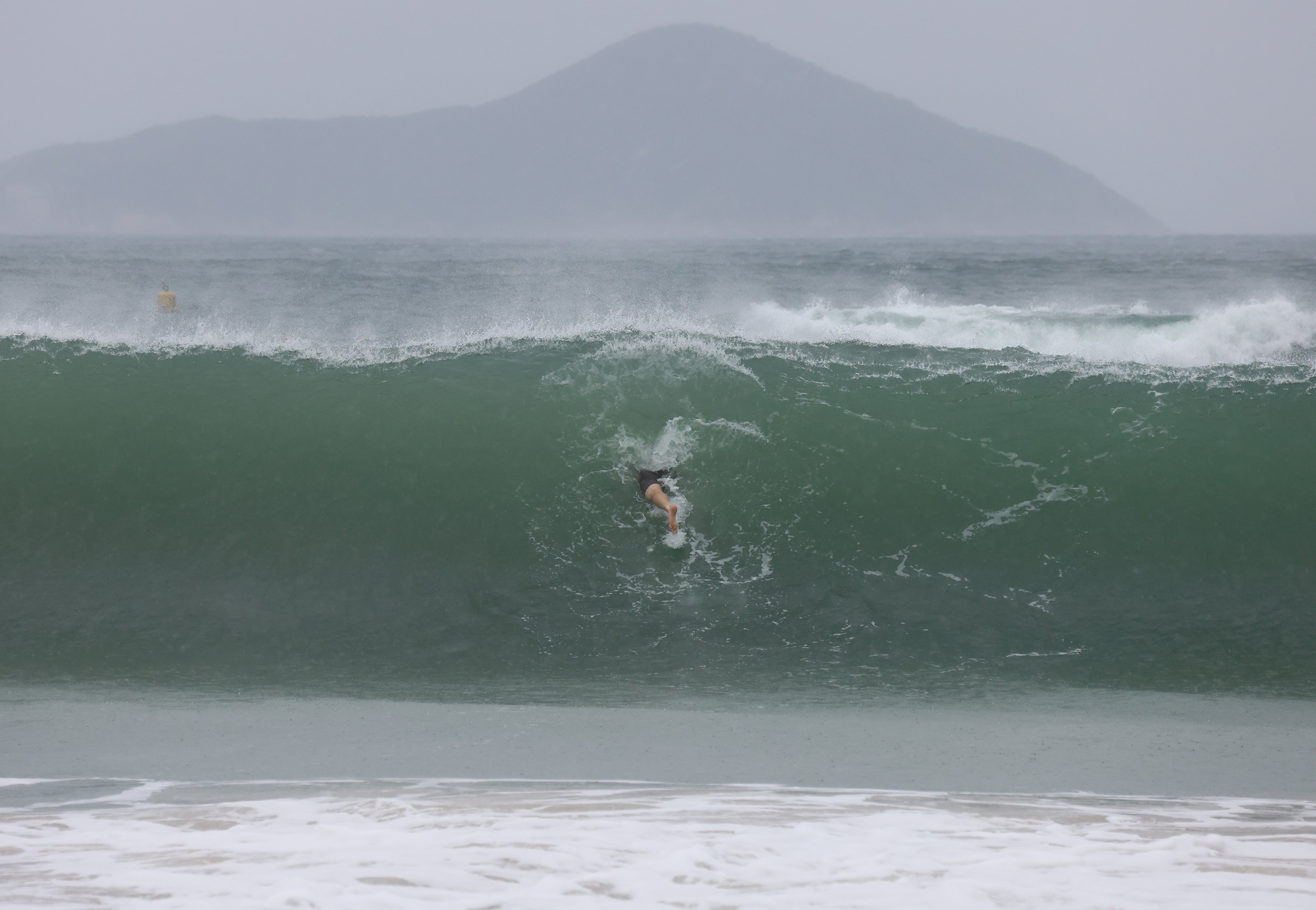 A surfer at Shek O ahead of a typhoon last year. When extreme weather warnings are up, steer clear of beaches. Photo: Dickson Lee