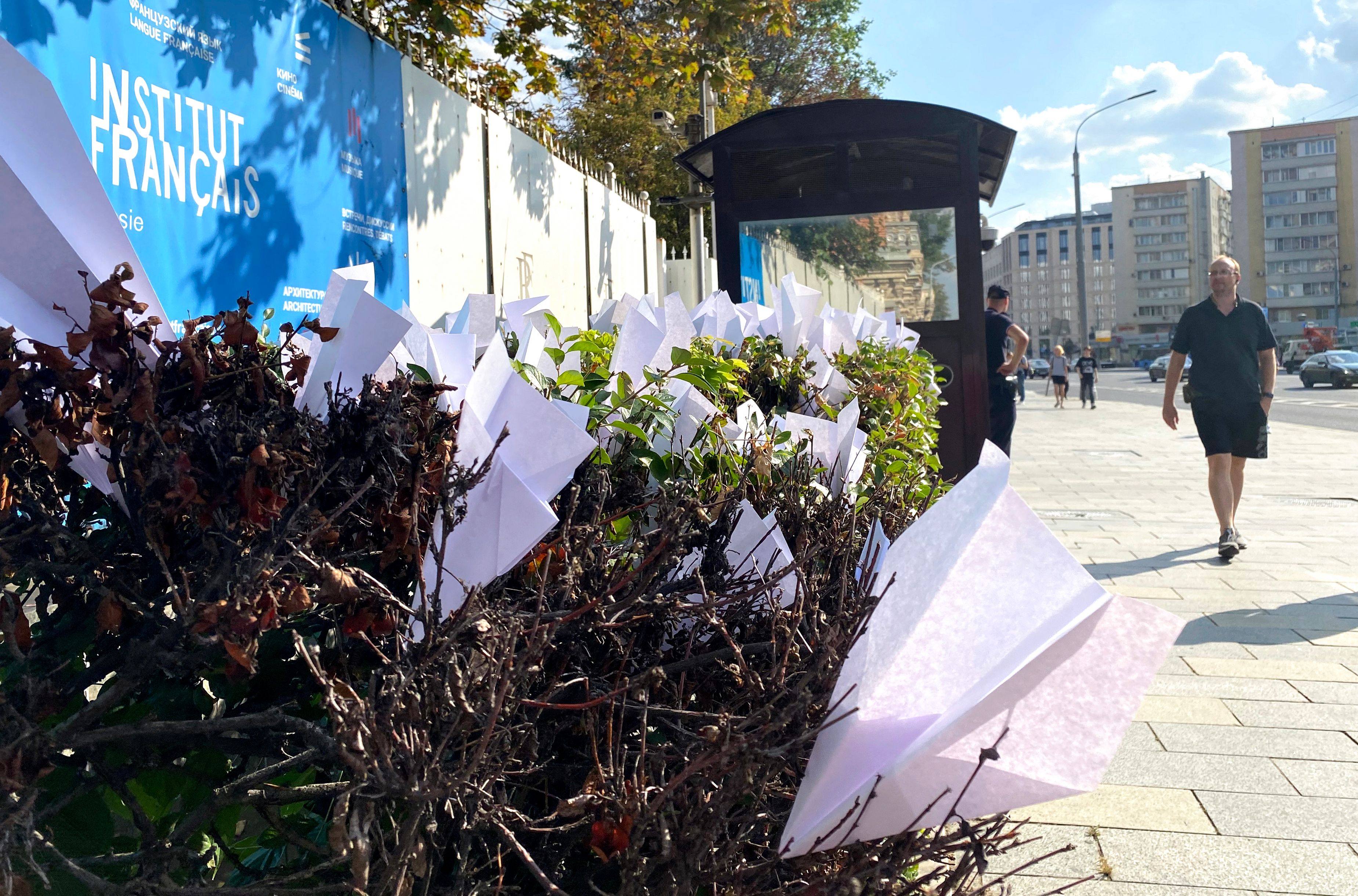 A pedestrian walks past paper planes displayed as a reference to the logo of instant messaging service company Telegram outside France’s embassy in central Moscow on August 25. Telegram’s CEO Pavel Durov was arrested last month at Le Bourget Paris airport for offences related to his messaging app. Photo: AFP