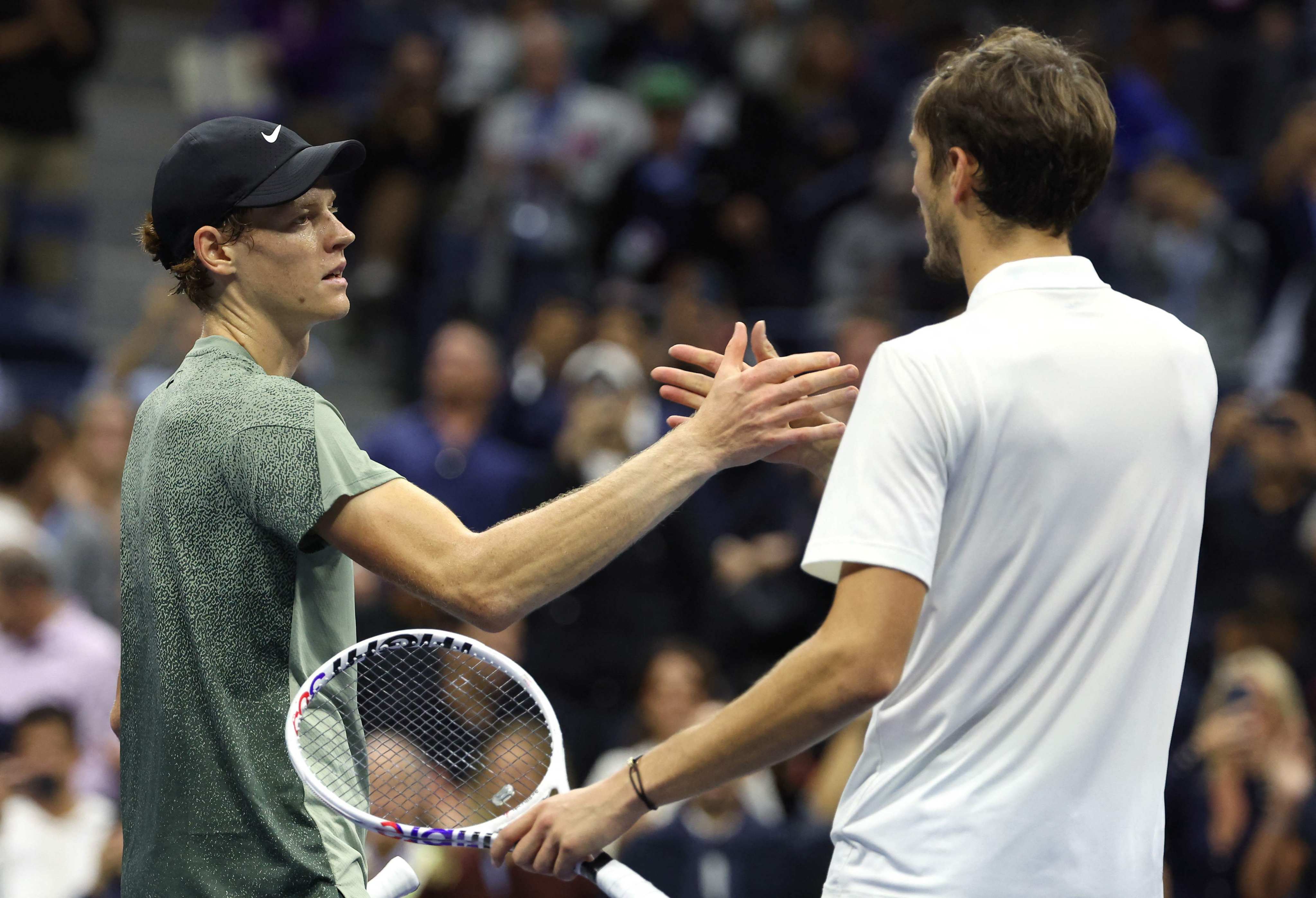 Jannik Sinner of Italy shakes hands with Daniil Medvedev of Russia after winning their quarter-final match at Flushing Meadows on Wednesday. Photo: AFP