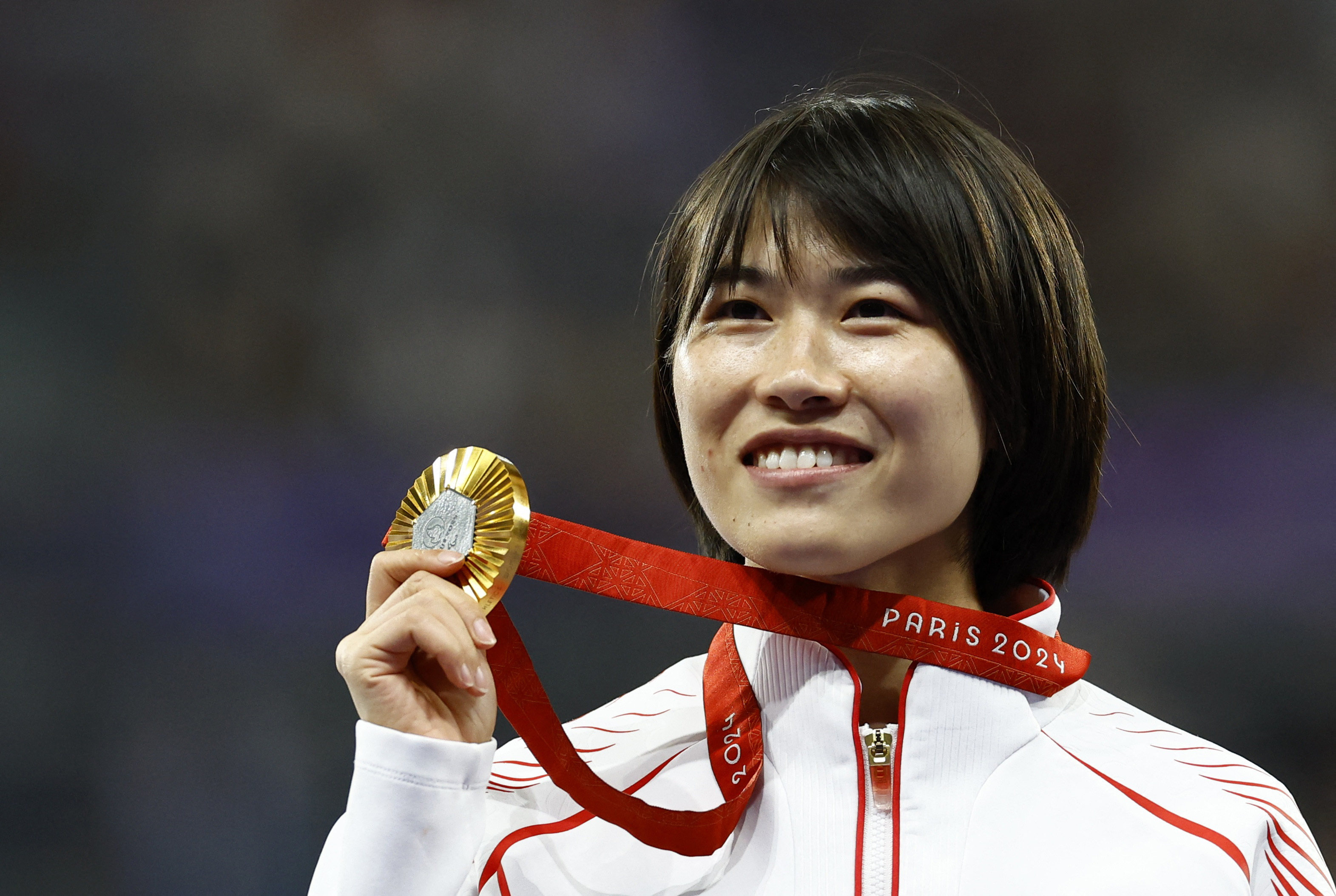 Gold medallist Shi Yiting celebrates winning the women’s T36 100m at the Stade de France. Photo: Reuters