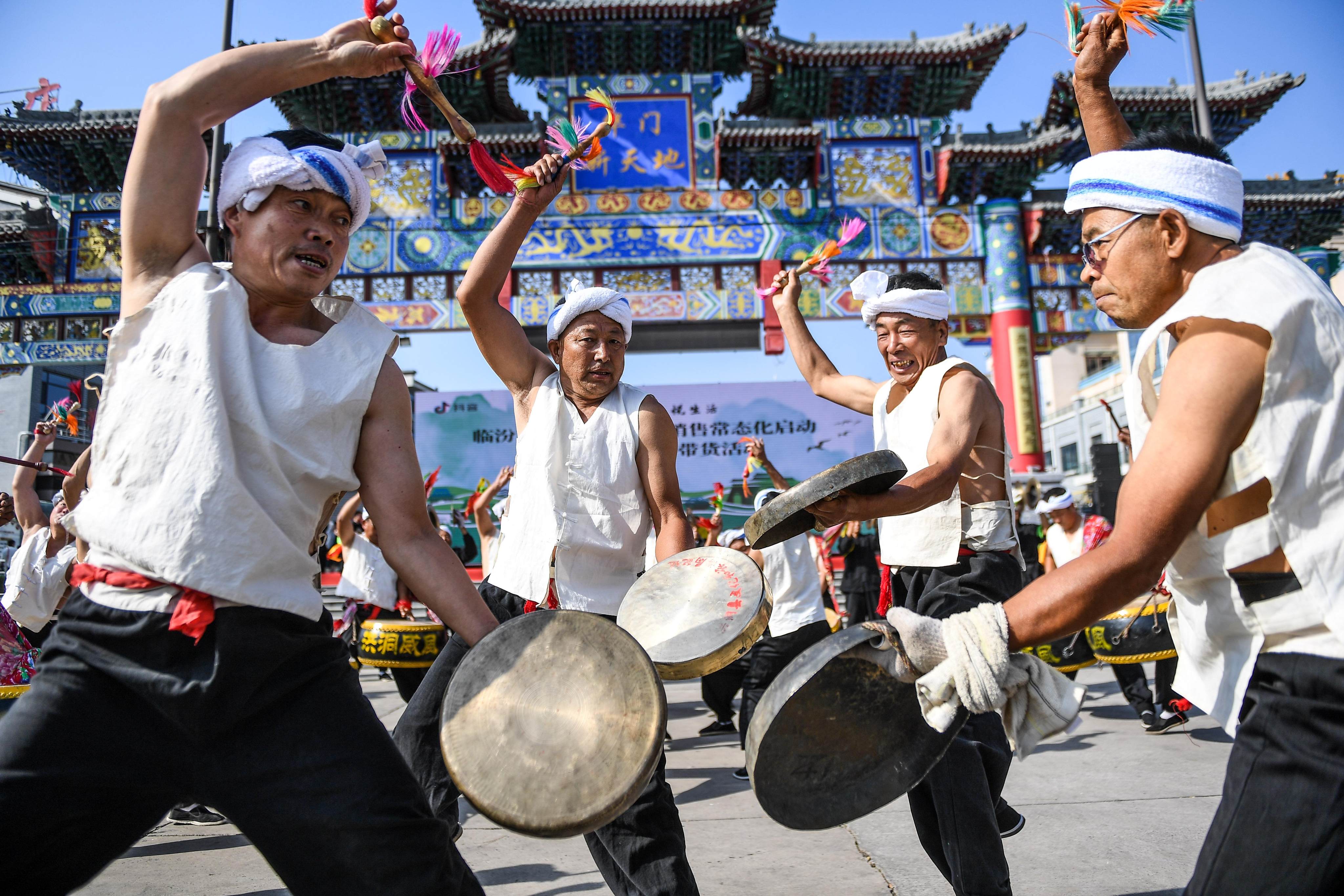 Performers strike hand-held gongs during cerebrations for the Dragon Boat Festival in Linfen, China, in 2020. Of the metal instruments played in a Chinese orchestra, gongs and chime bells are the most common. Photo: Getty Images