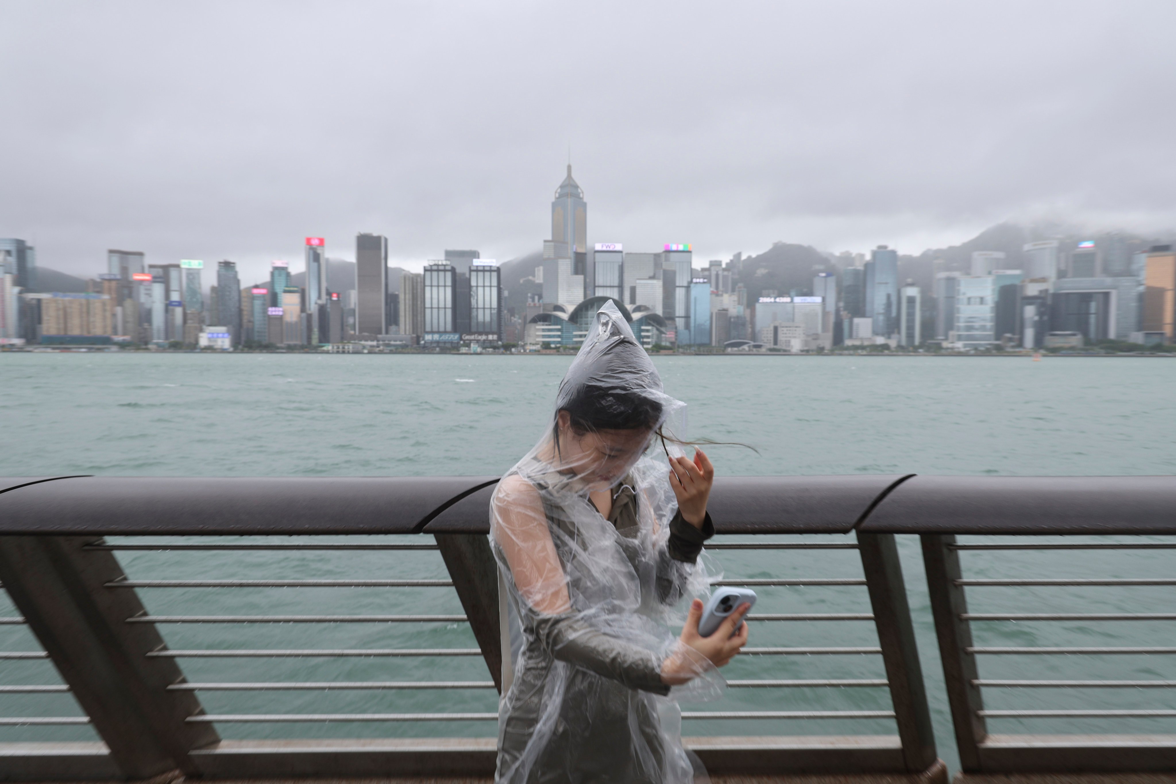 A woman stands near the waterfront in Tsim Sha Tsui as Super Typhoon Yagi nears Hong Kong. Photo: Dickson Lee