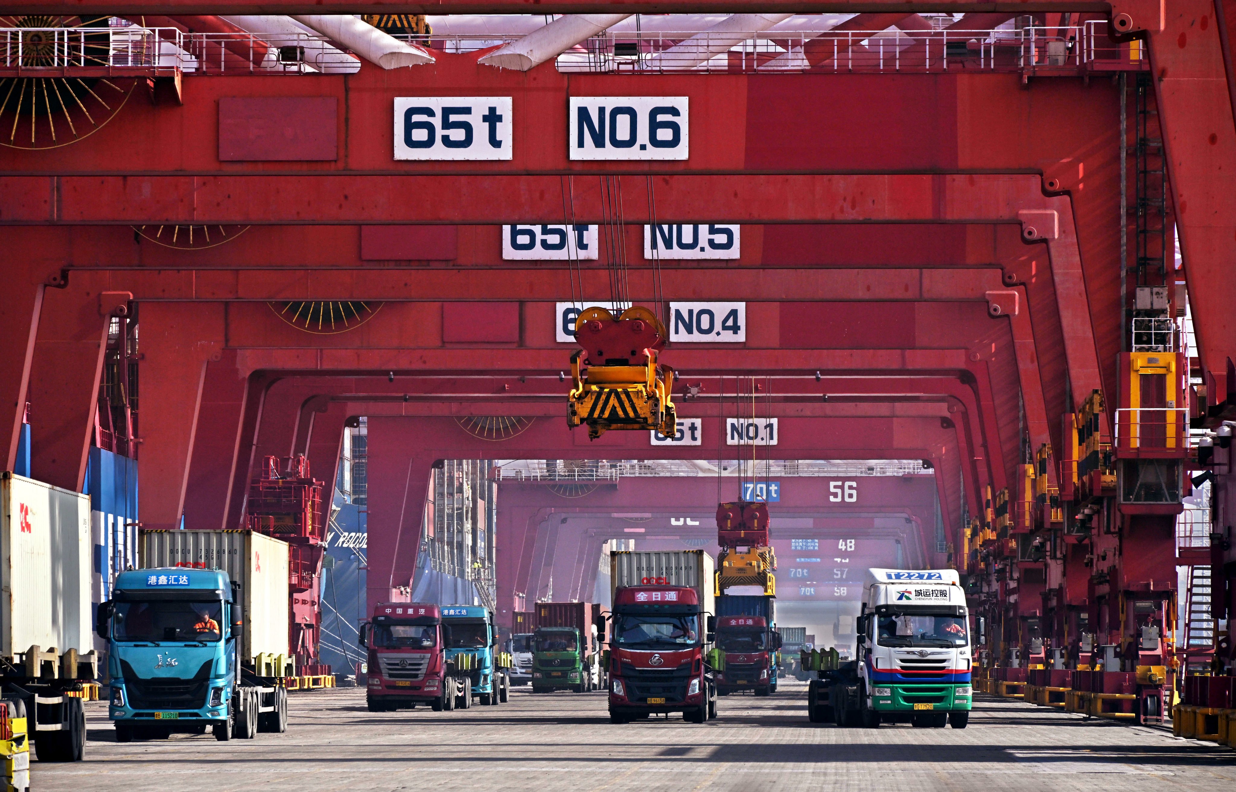 Trucks transport containers at Qingdao Port, east China’s Shandong Province, in February. Photo: Xinhua