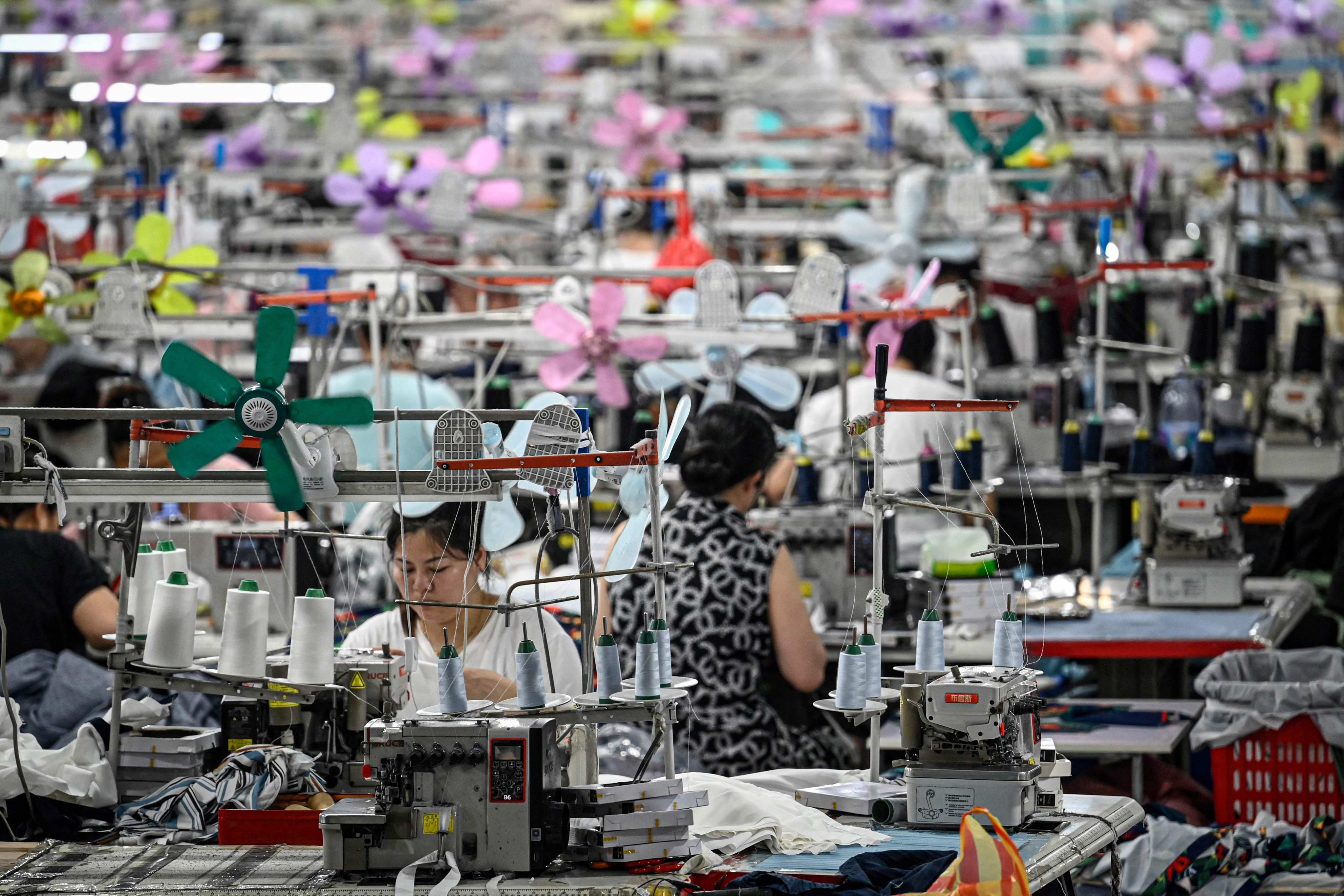 Workers produce garments at a textile factory that supplies clothes to a Chinese e-commerce platform in Guangzhou, southern China’s Guangdong province, in June. Photo: AFP