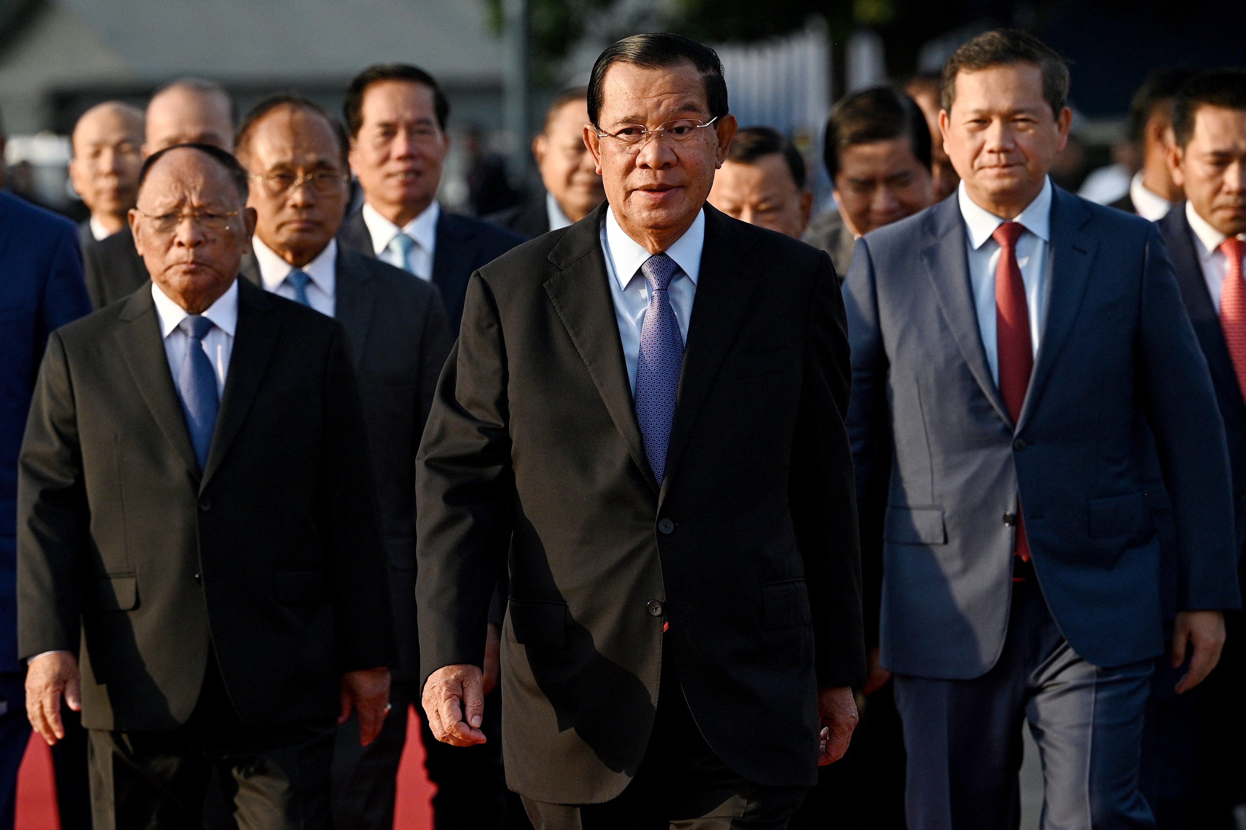 Cambodia’s Prime Minister Hun Manet (right) walks behind his father Hun Sen, president of the Cambodian People’s Party and Cambodia’s Senate, in Phnom Penh in January. Photo: AFP