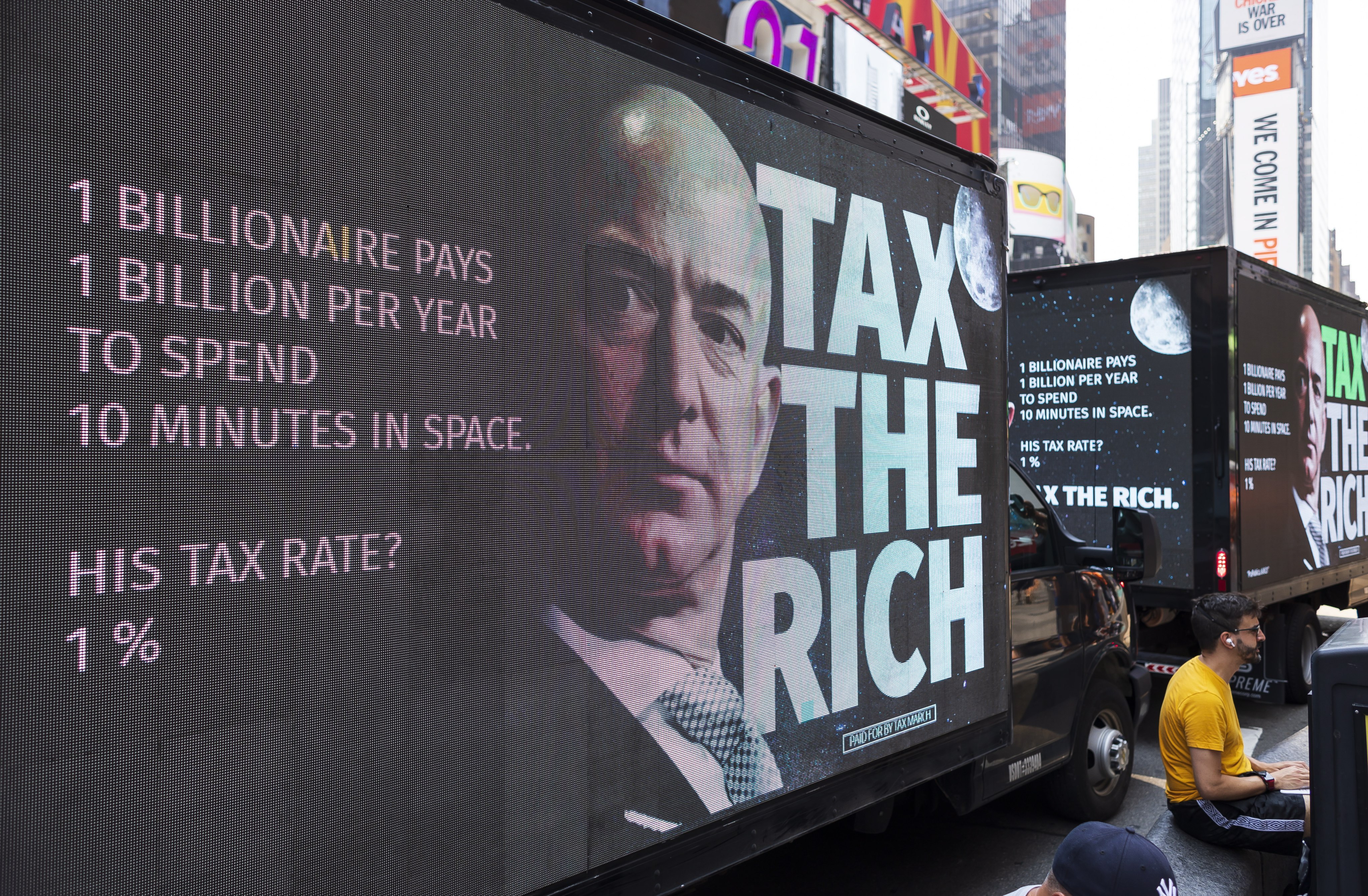 Mobile billboards on trucks parked near a small rally calling for a higher tax rate on the wealthiest Americans in Times Square in New York on July 27, 2021. Photo: EPA-EFE