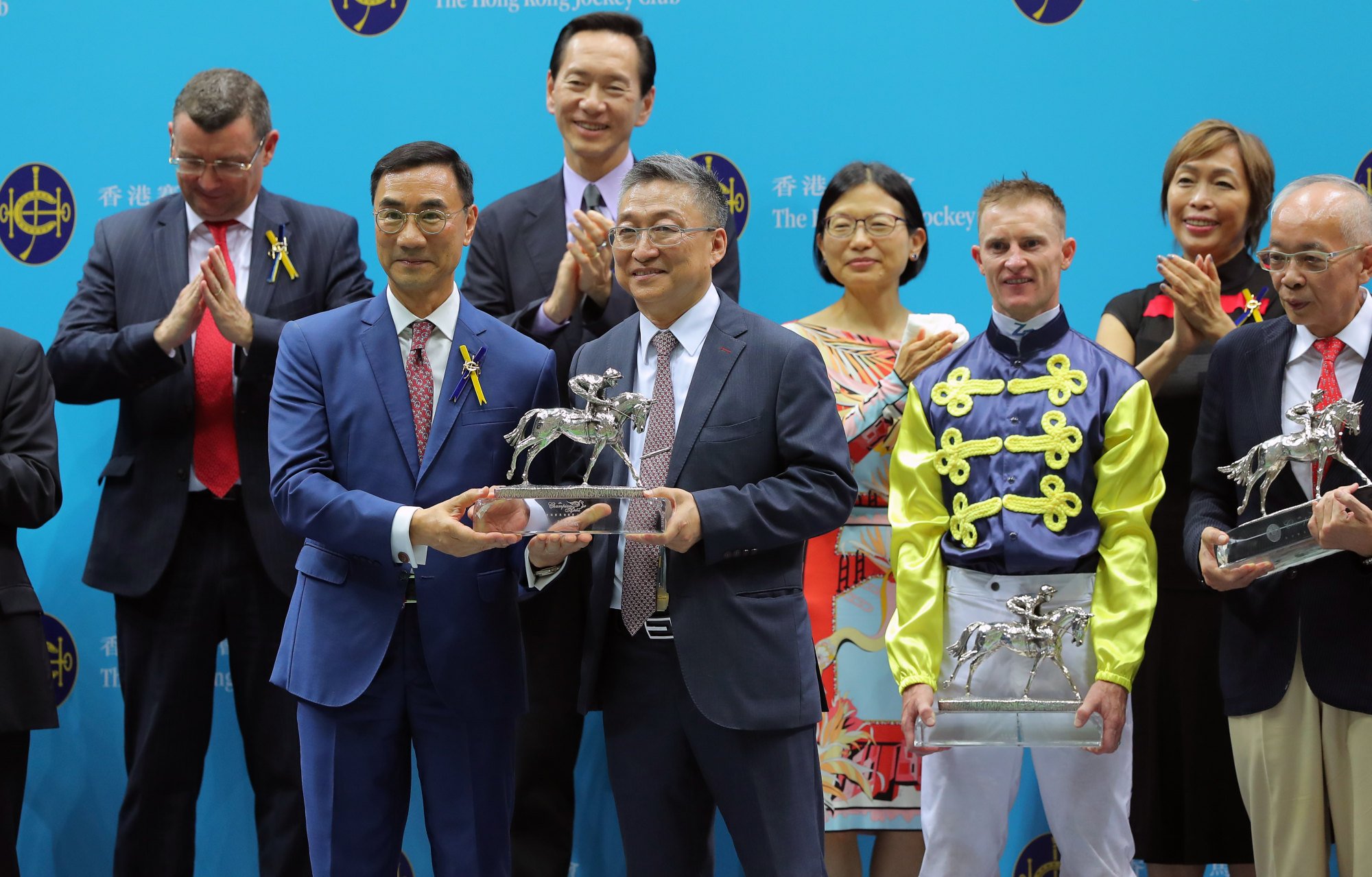 Trainer Francis Lui receives his champion trainer trophy from Jockey Club chairman Michael Lee.