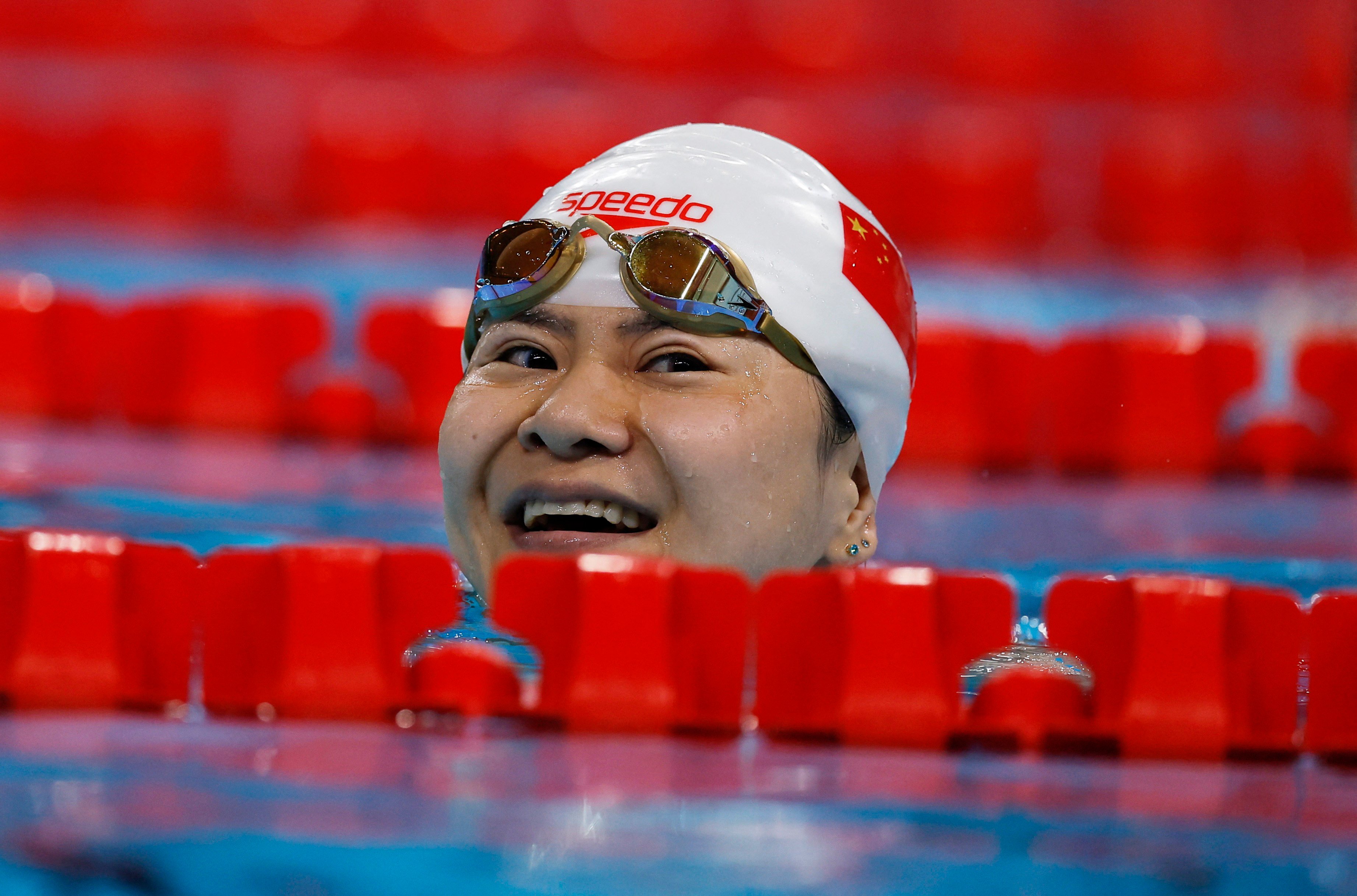 China’s Lu Dong peers over a lane separator after winning gold in the women’s 50m butterfly S5 final at the Paris Paralympics. Photo: Reuters