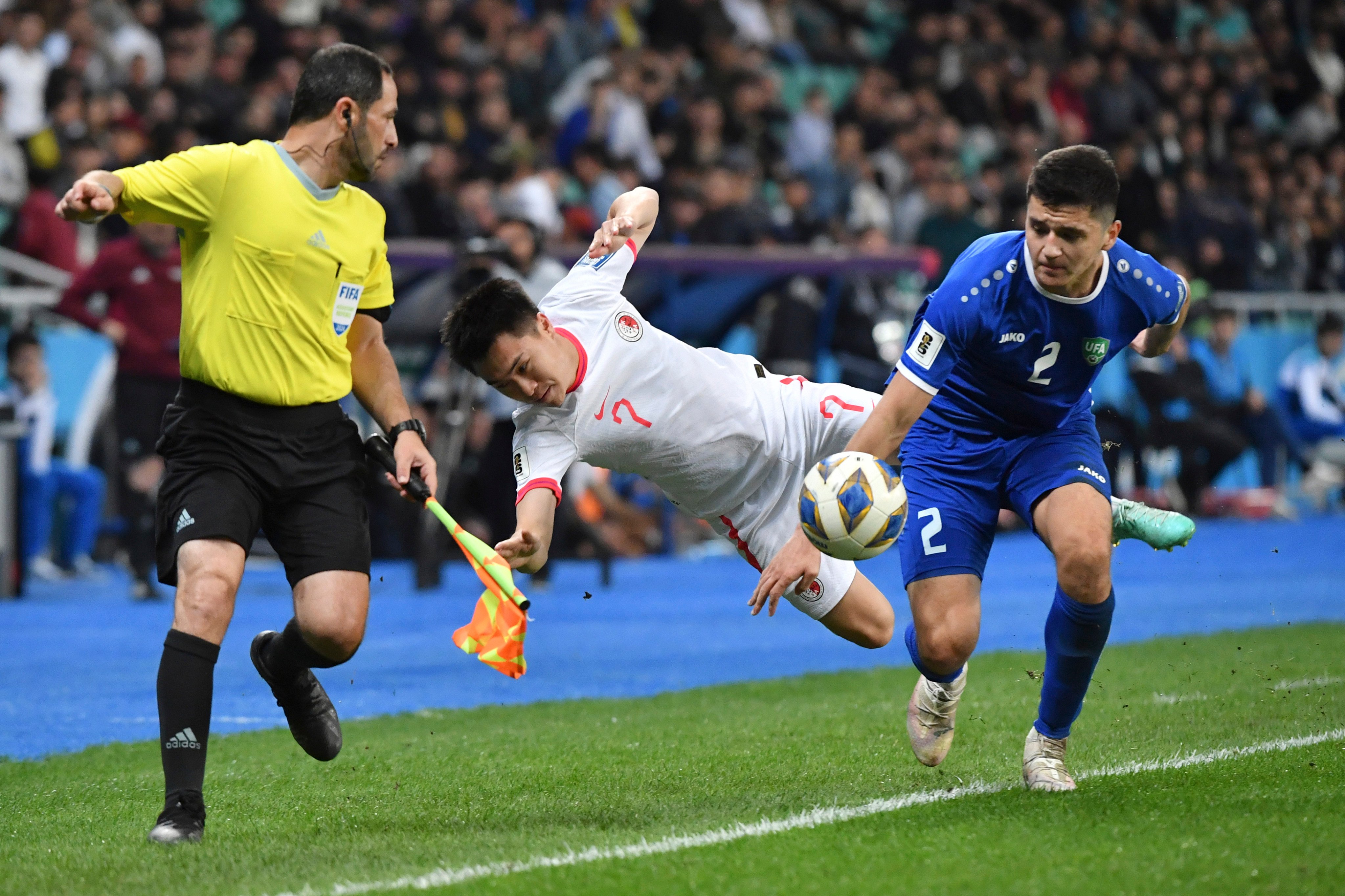 Hong Kong’s Yu Joy Yin Jessie (centre) battles for the ball with Uzbekistan’s Abdukodir Khusanov during an Asian qualifier match for the 2026 Fifa World Cup in March. Photo: AP Photo