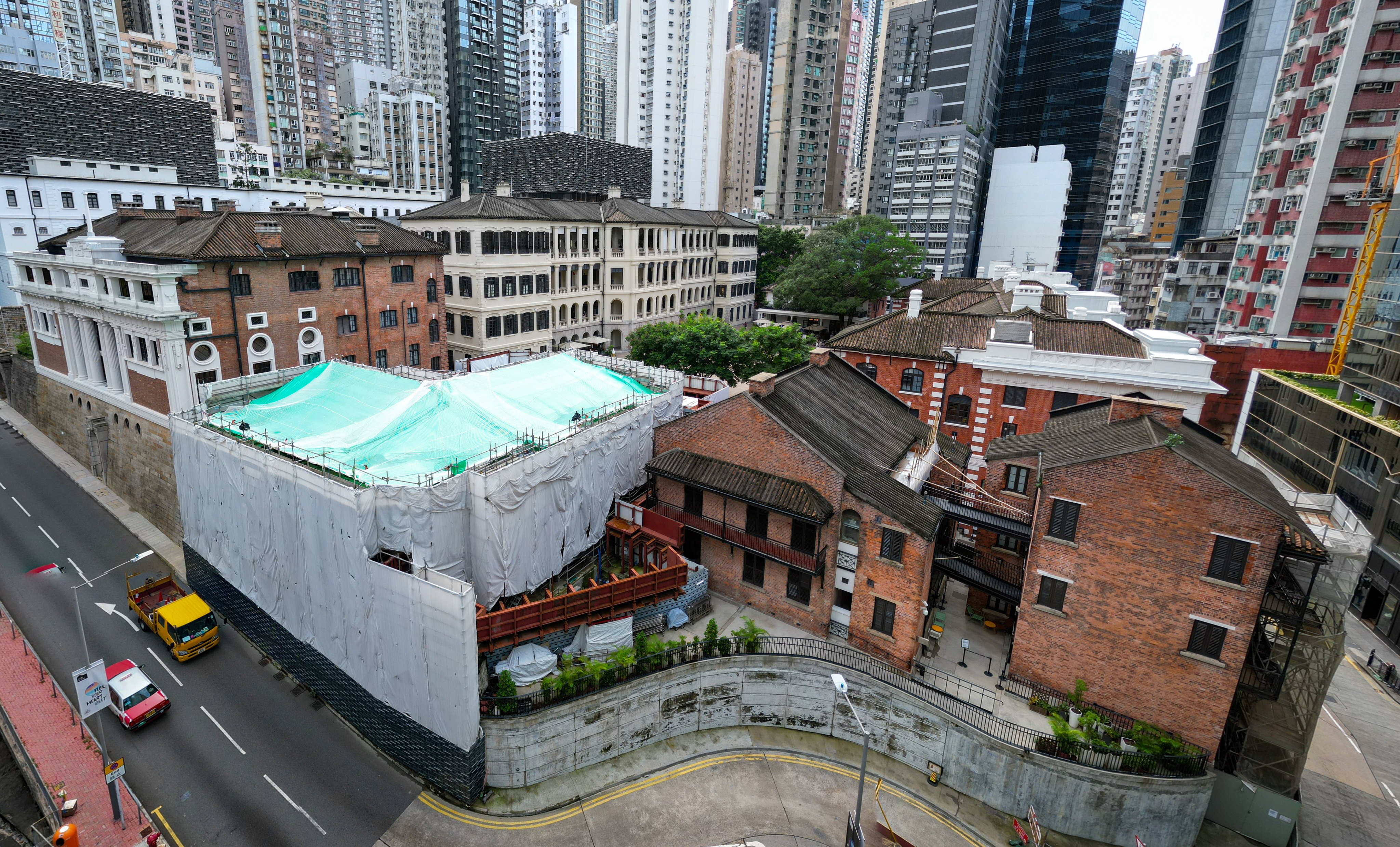 Block 4 (under cover) in the compound partially collapsed eight years ago Photo: Dickson Lee