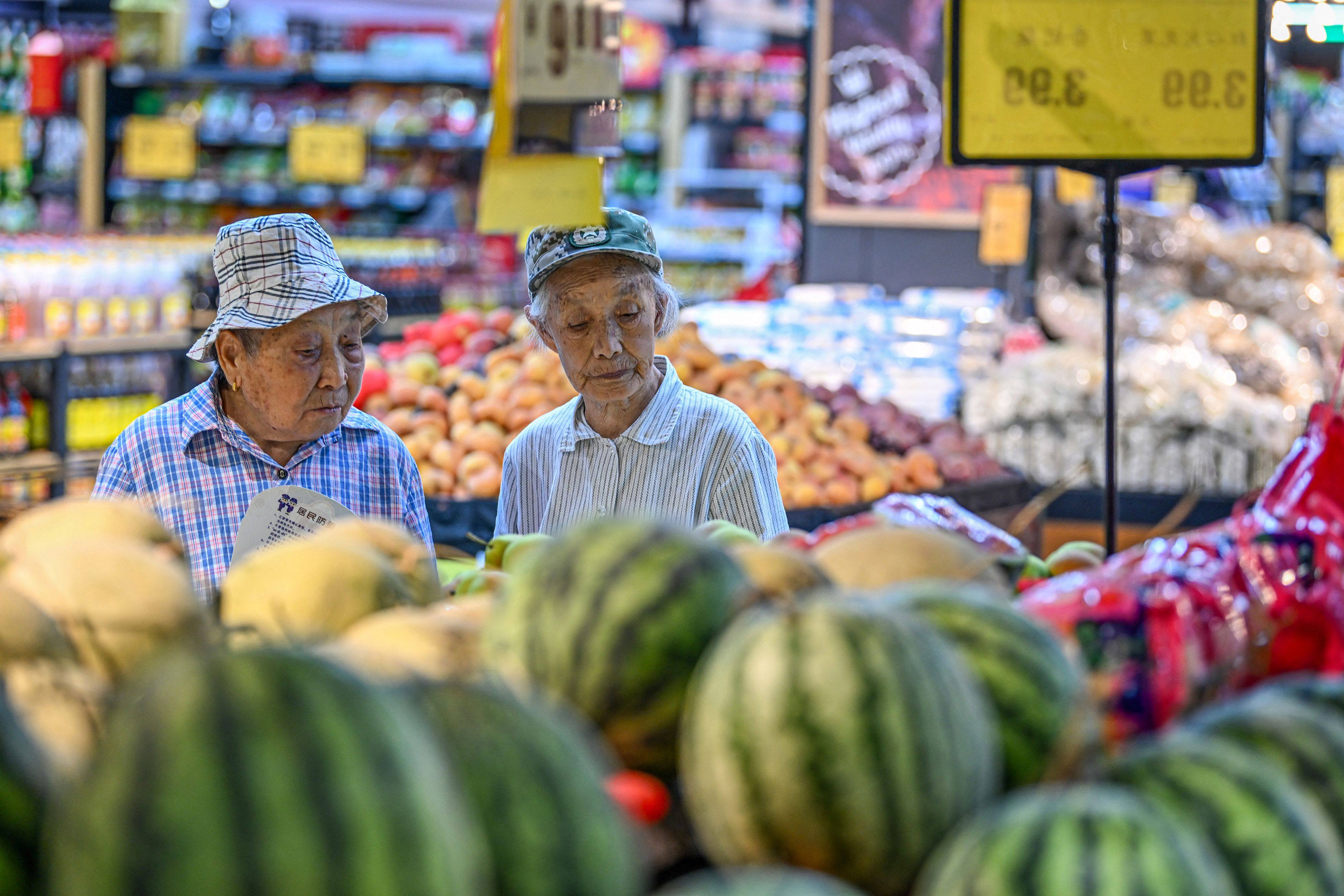 People shop for fruits and vegetables at a supermarket in Nanjing, in eastern China’s Jiangsu province. Photo: AFP