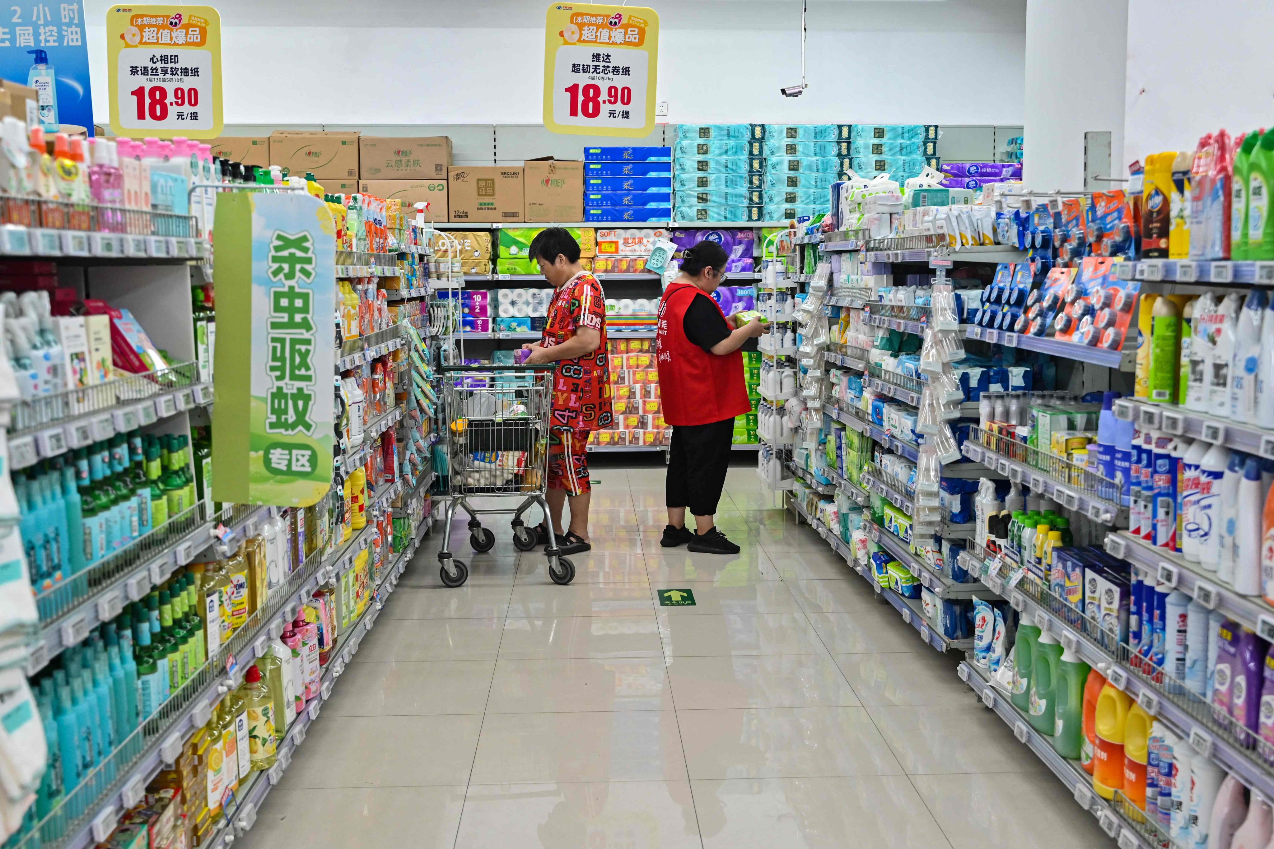 People buy goods at a supermarket in Beijing. Photo: AFP
