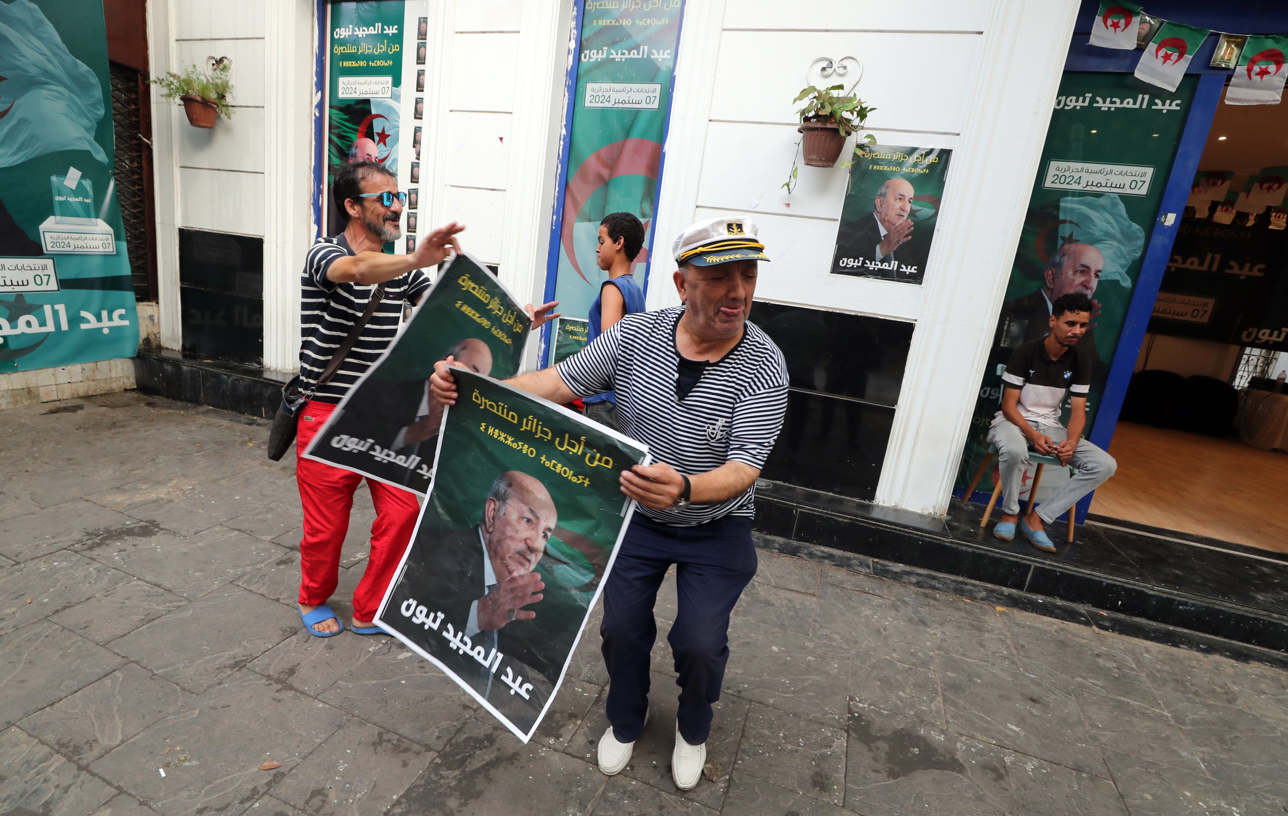 Algerian men celebrate the re-election of Abdelmadjid Tebboune in Algiers, Algeria on Sunday. Photo: EPA-EFE