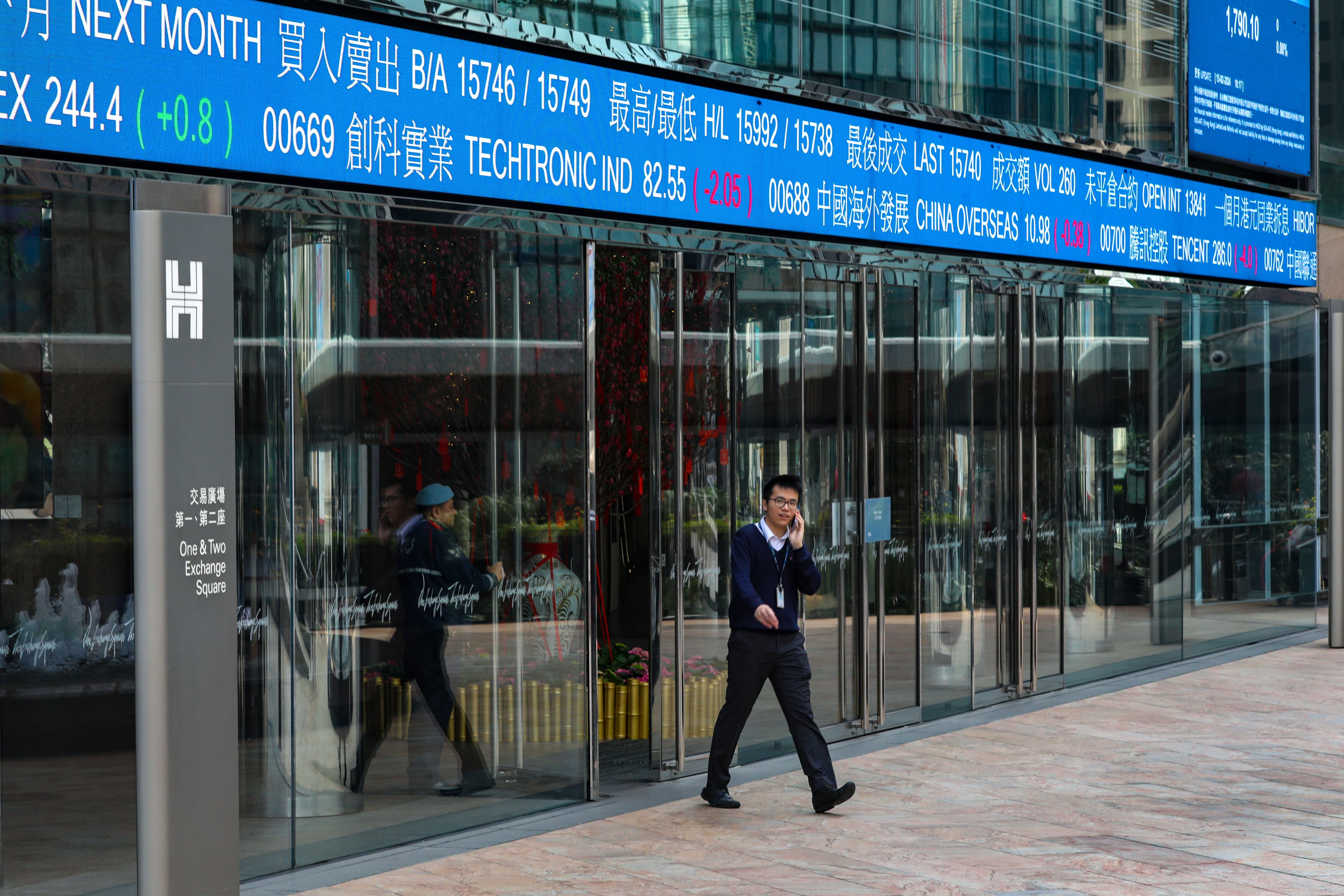 Screens showing stock indices and prices outside the Exchange Square in Central. Photo: Sun Yeung