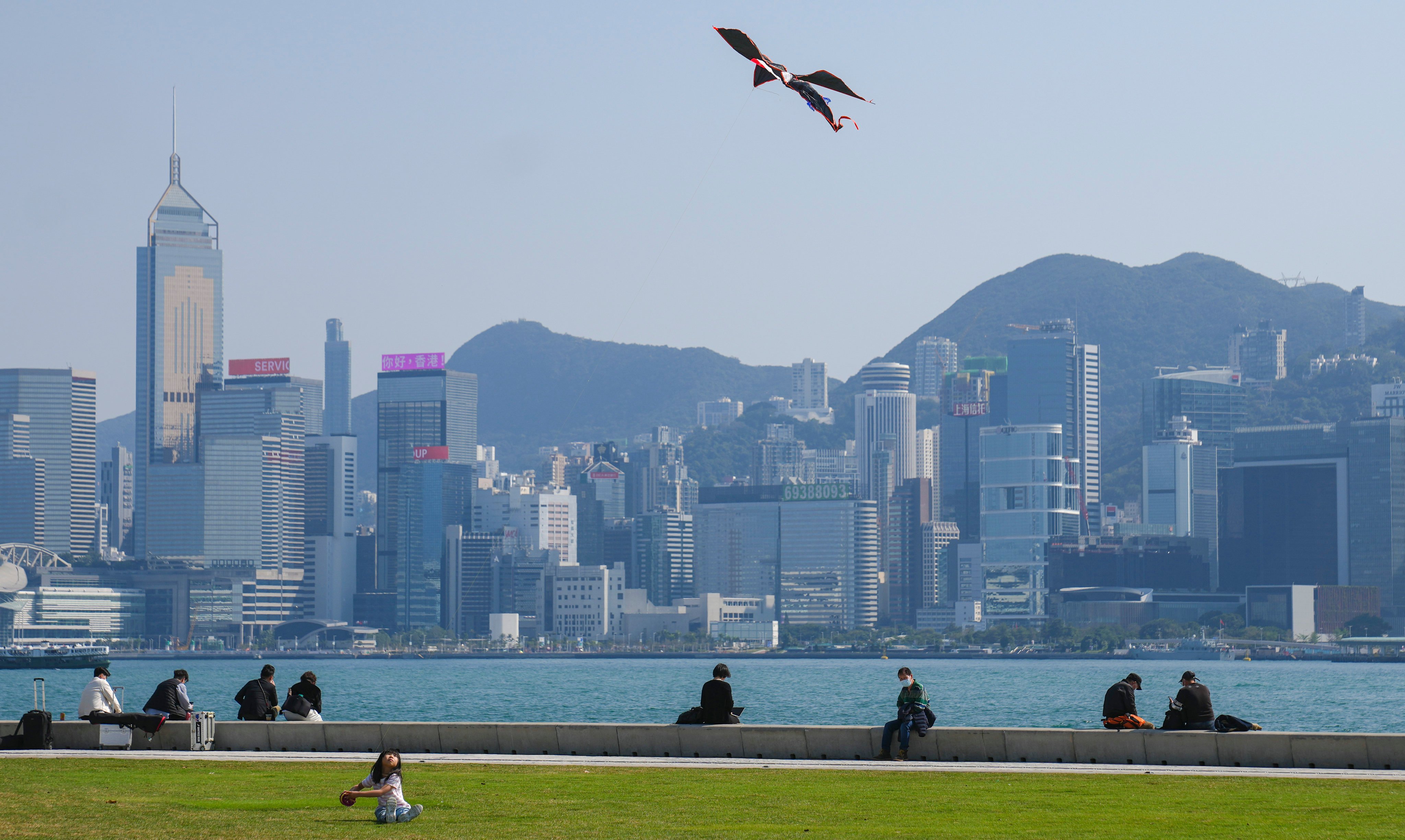 A child flies a kite at the waterfront in West Kowloon Cultural District, across from the harbour from Hong Kong’s financial district, on February 15, 2023. Photo: Sam Tsang