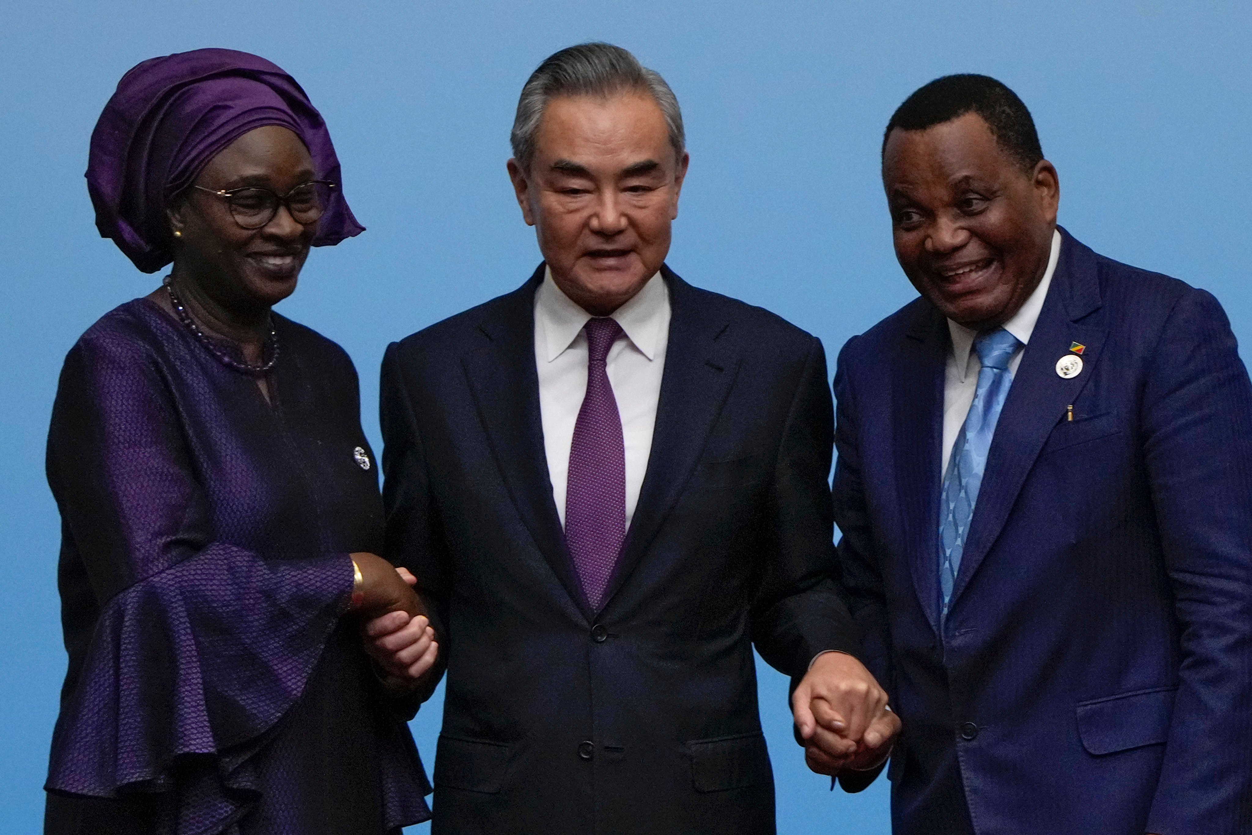 China’s foreign minister Wang Yi (centre) holds hands with his counterparts, Senegal’s Yassine Fall (left) and Congo’s Jean-Claude Gakosso after a joint press conference at the Forum of China-Africa Cooperation on September 5 in Beijing. Photo: AP